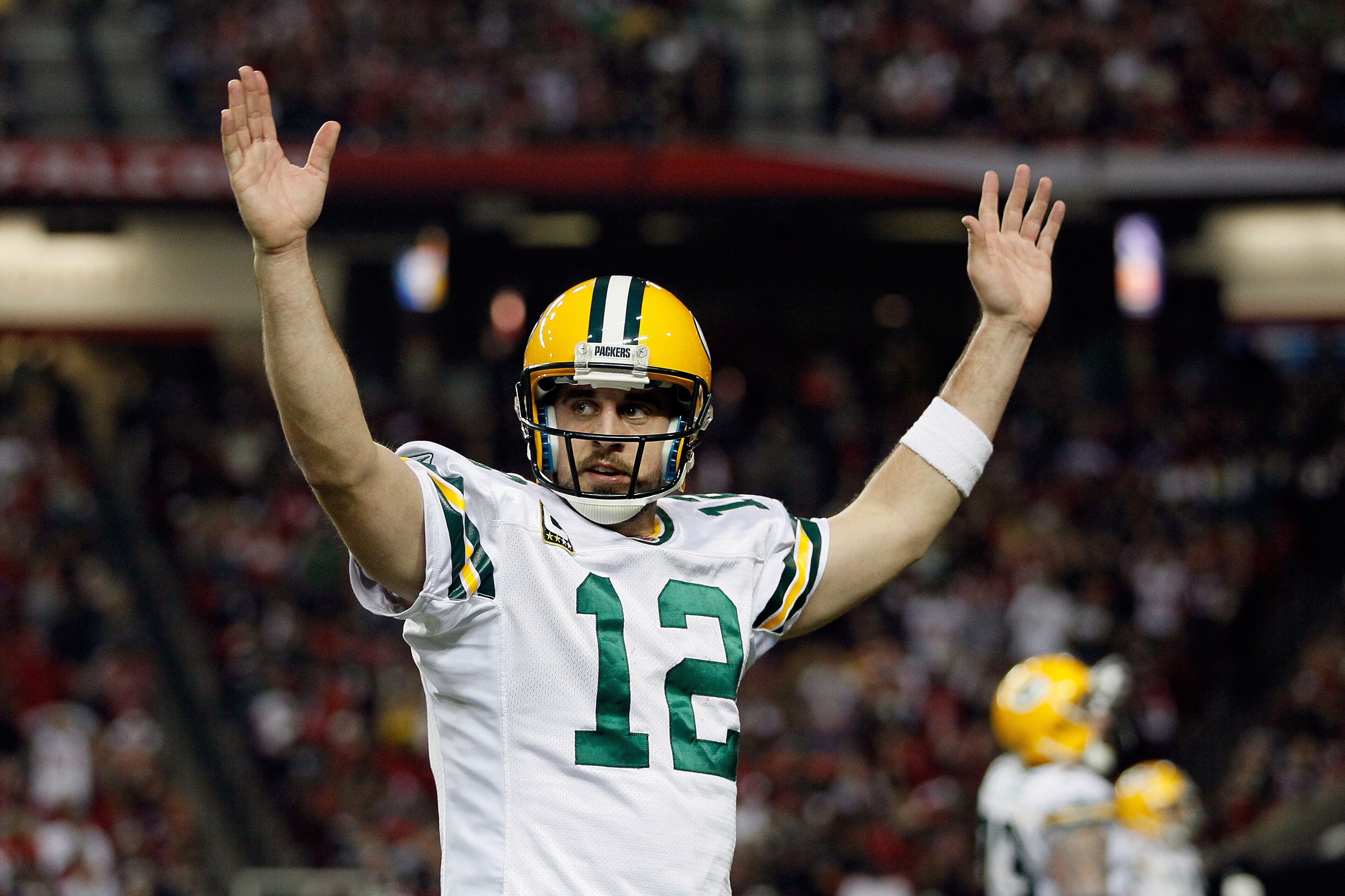 ATLANTA, GA - JANUARY 15:  Aaron Rodgers #12 of the Green Bay Packers reacts after he threw a 7-yard touchdown to John Kuhn #30 in the third quarter against the Atlanta Falcons during their 2011 NFC divisional playoff game at Georgia Dome on January 15, 2