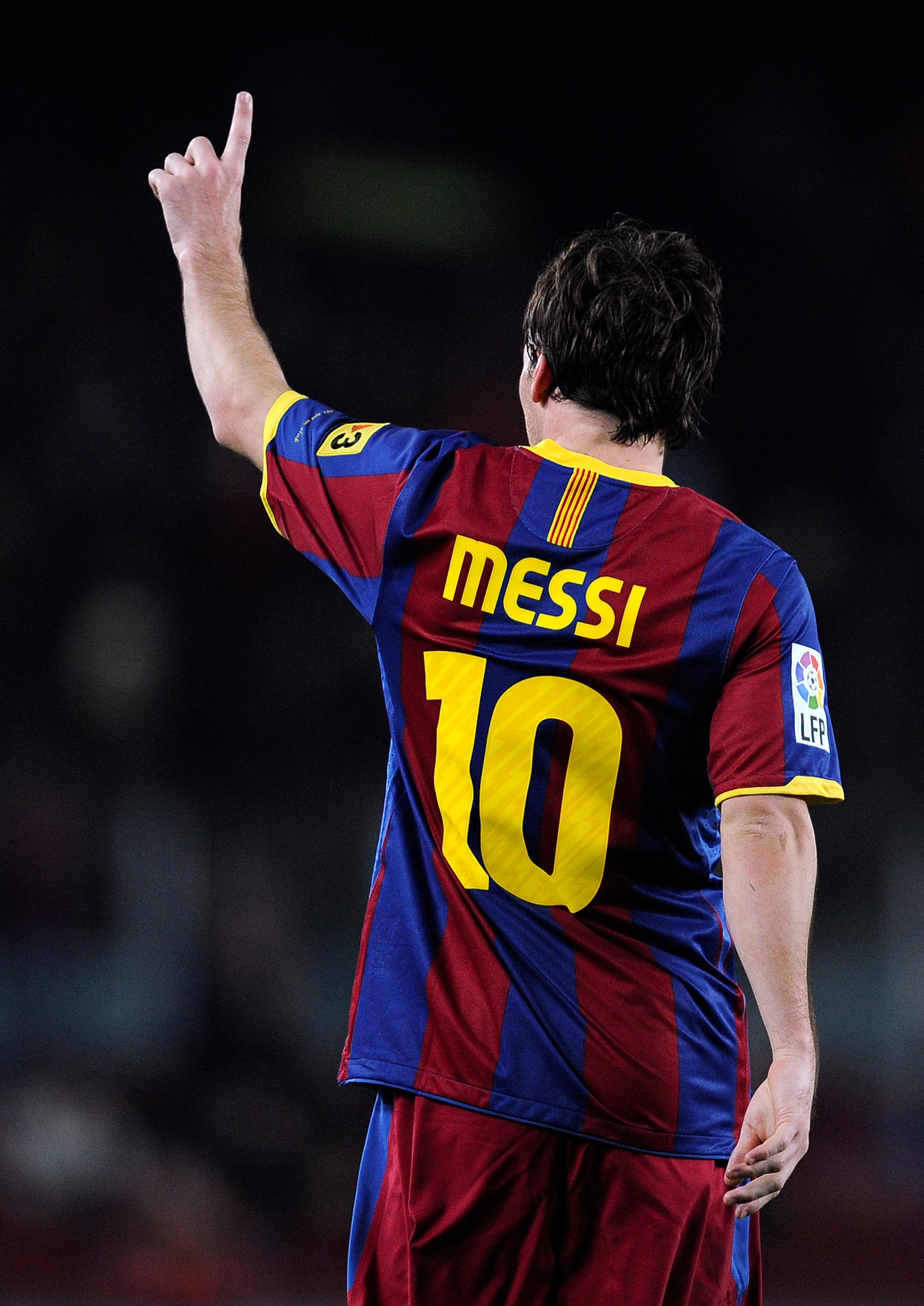 BARCELONA, SPAIN - JANUARY 12:  Lionel Messi of FC Barcelona (R) celebrates after scoring his side's first goal during the Copa del Rey quarter final first leg match between FC Barcelona and Betis at Camp Nou on January 12, 2011 in Barcelona, Spain. Barce