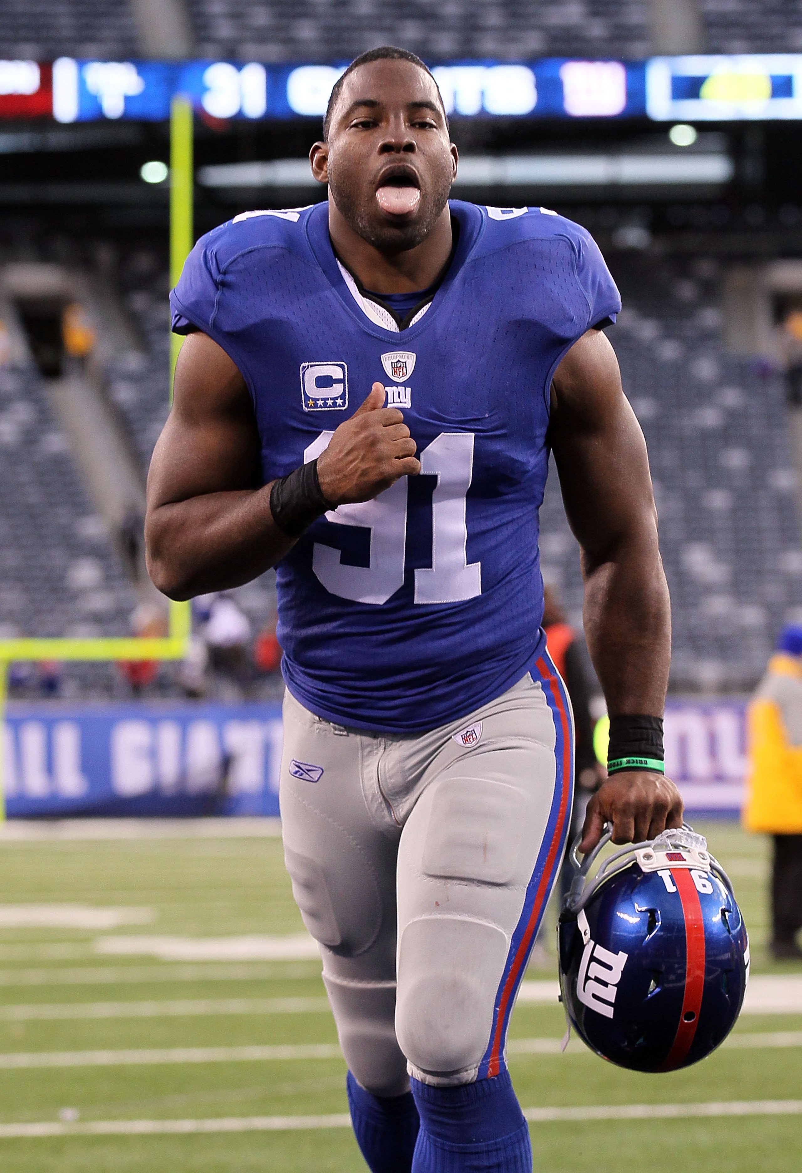 EAST RUTHERFORD, NJ - DECEMBER 05:  Justin Tuck #91 of the New York Giants celebrates after defeating the Washington Redskins on December 5, 2010 at the New Meadowlands Stadium in East Rutherford, New Jersey. The Giants defeated the Redskins 31-7.  (Photo