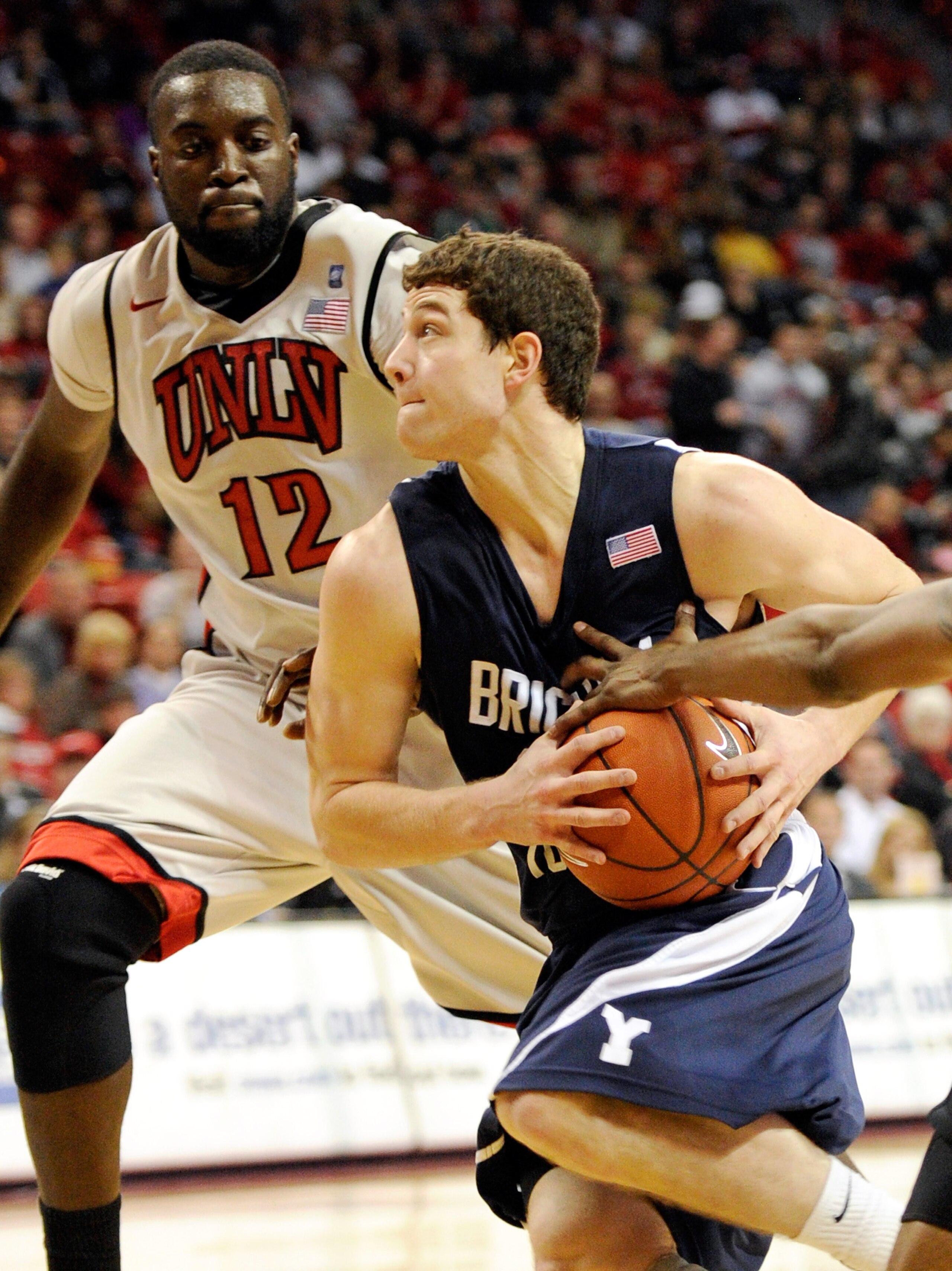 LAS VEGAS, NV - JANUARY 05: Jimmer Fredette #32 of the Brigham Young University Cougars drives against Brice Massamba #12 of the UNLV Rebels during their game at the Thomas & Mack Center January 5, 2011 in Las Vegas, Nevada. BYU won 89-77. (Photo by Eth LAS VEGAS, NV - JANUARY 05: Jimmer Fredette #32 of the Brigham Young University Cougars drives against Brice Massamba #12 of the UNLV Rebels during their game at the Thomas & Mack Center January 5, 2011 in Las Vegas, Nevada. BYU won 89-77. (Photo by Eth