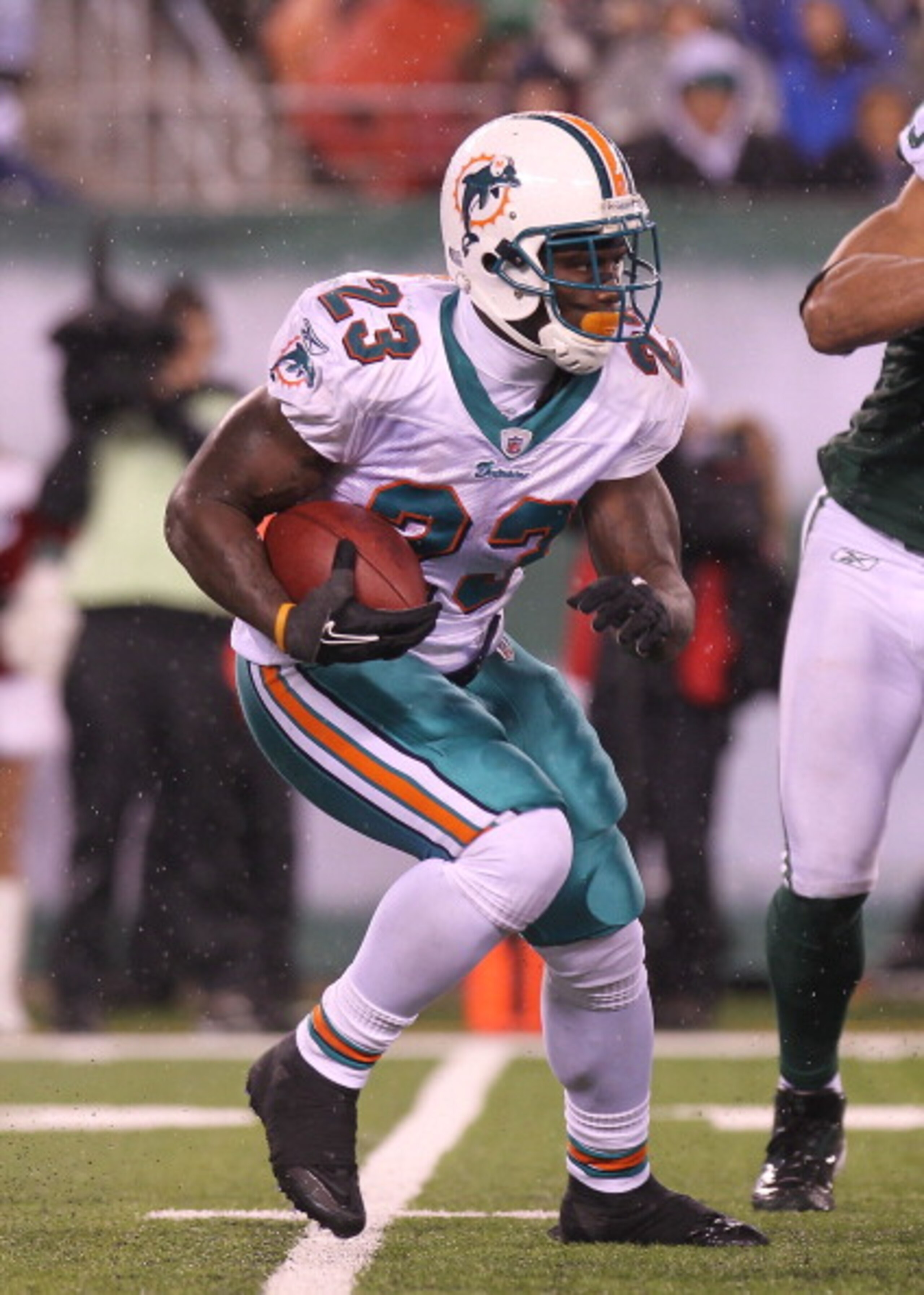 EAST RUTHERFORD, NJ - DECEMBER 12:  Ronnie Brown #23 of the Miami Dolphins rushes against the New York Jets at New Meadowlands Stadium on December 12, 2010 in East Rutherford, New Jersey.  (Photo by Nick Laham/Getty Images)