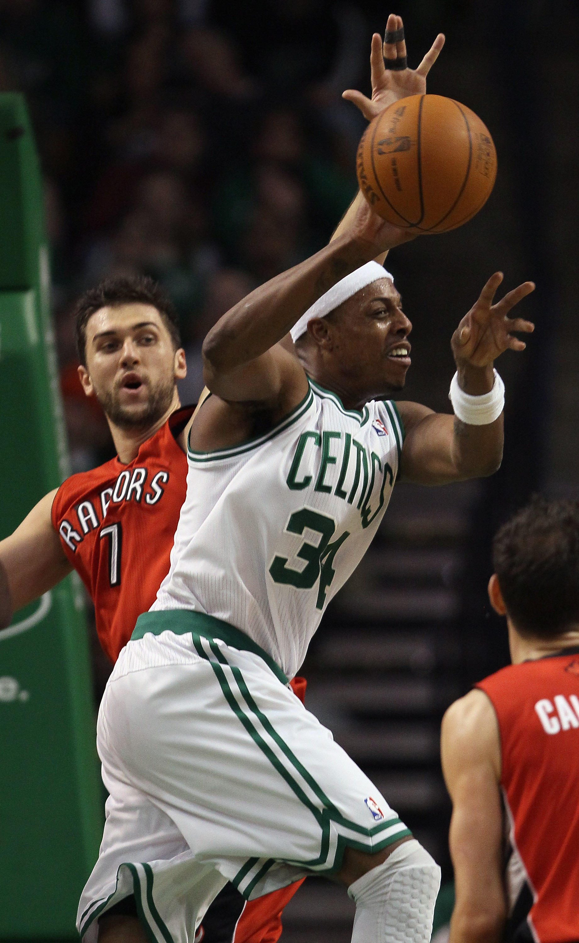 BOSTON, MA - JANUARY 07:  Paul Pierce #34 of the Boston Celtics passes the ball as Andrea Bargnani #7 of the Toronto Raptors defends on January 7, 2011 at the TD Garden in Boston, Massachusetts. The Celtics defeated the Raptors 122-102. NOTE TO USER: User