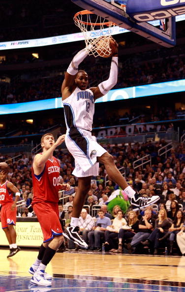 ORLANDO, FL - DECEMBER 18:  Dwight Hoawrd #12 of the Orlando Magic grabs a rebound over Spencer Hawes #00 of the Philadelphia 76ers during the game at Amway Arena on December 18, 2010 in Orlando, Florida.  NOTE TO USER: User expressly acknowledges and agr