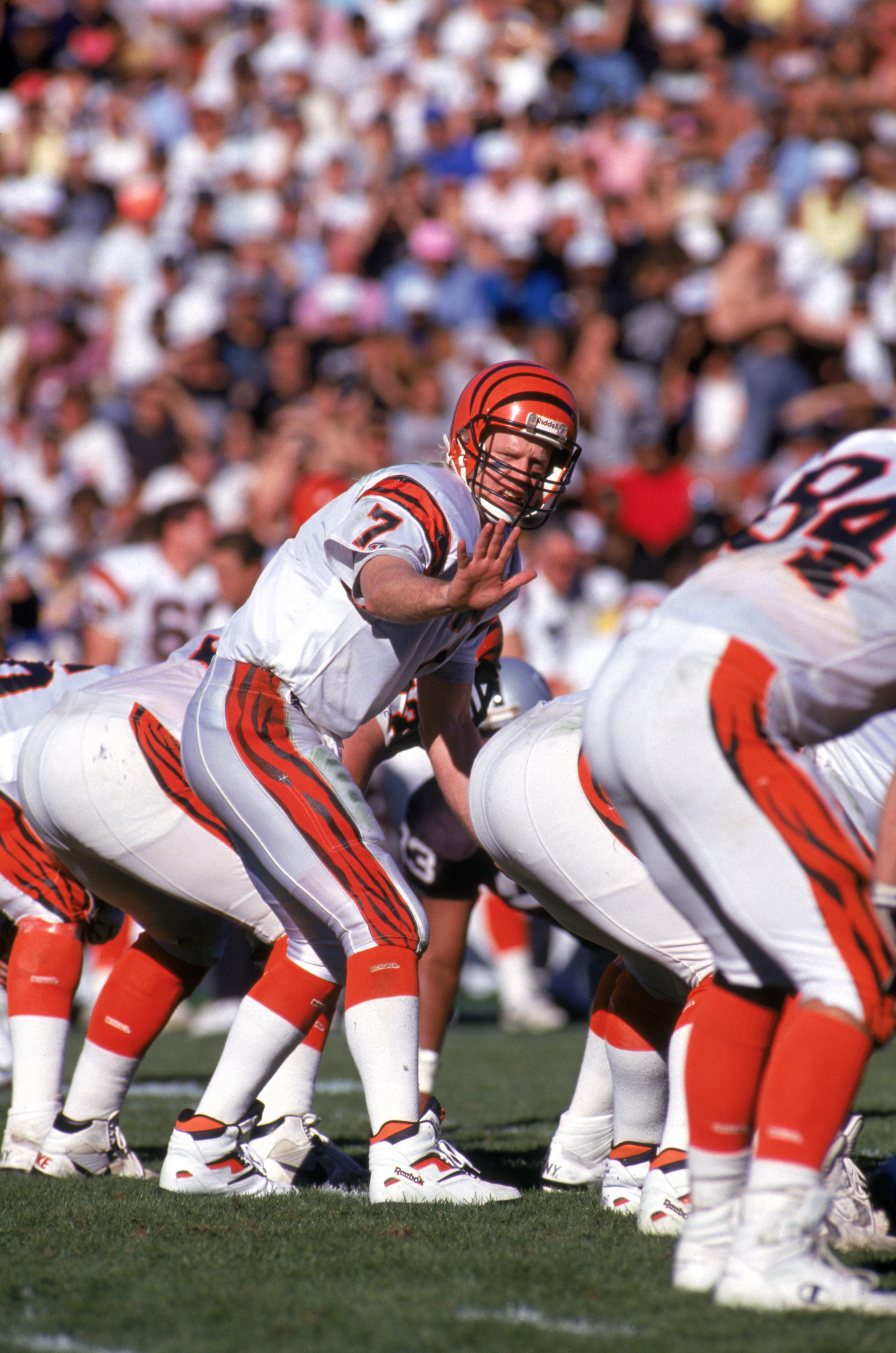 LOS ANGELES - JANUARY 13:  Quarterback Boomer Esiason #7 of the Cincinnati Bengals calls a play at the line of scrimmage during a 1990 AFC Divisional Playoff game against the Los Angeles Raiders at the Los Angeles Memorial Coliseum on January 13, 1991 in