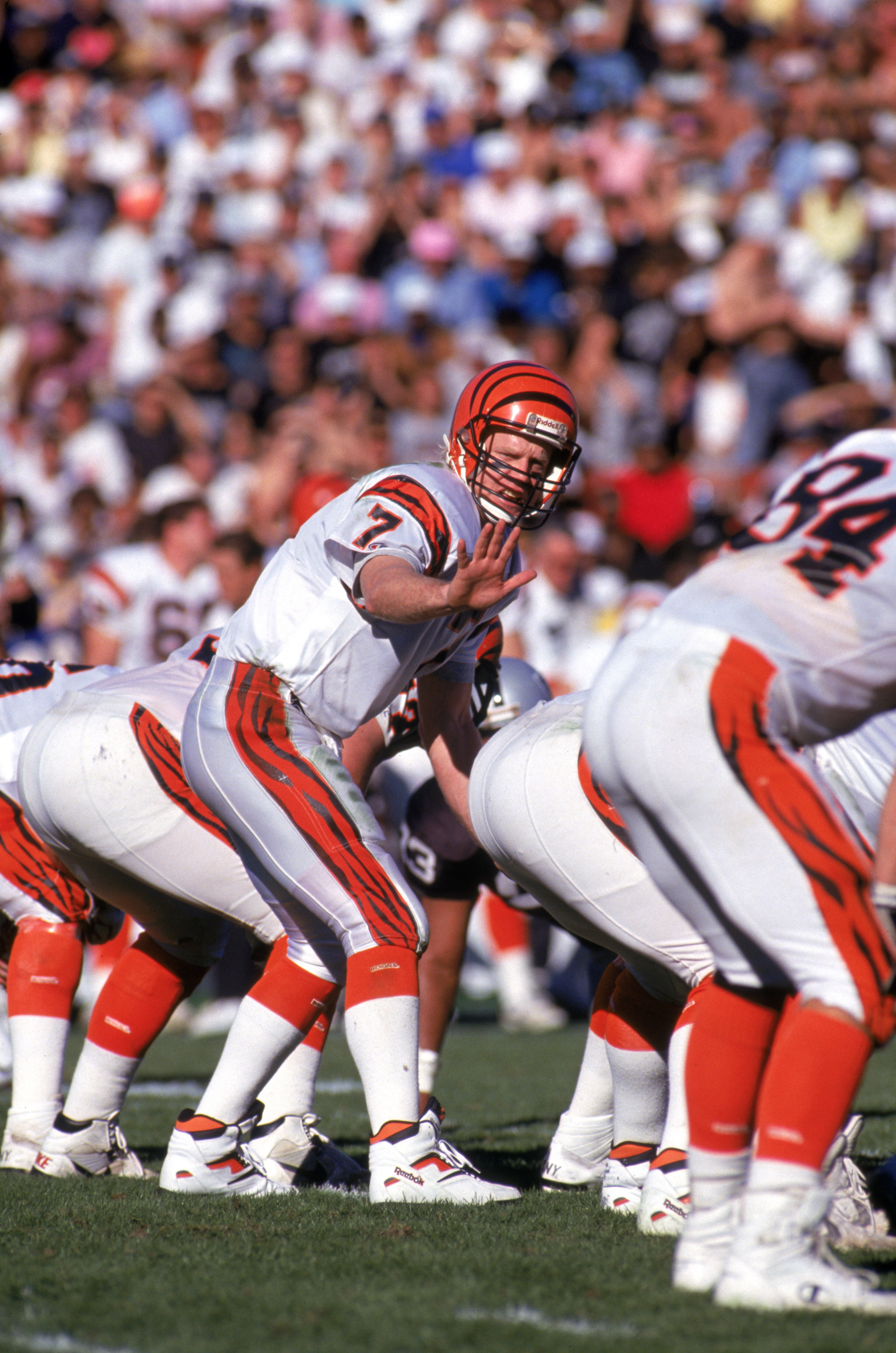 LOS ANGELES - JANUARY 13:  Quarterback Boomer Esiason #7 of the Cincinnati Bengals calls a play at the line of scrimmage during a 1990 AFC Divisional Playoff game against the Los Angeles Raiders at the Los Angeles Memorial Coliseum on January 13, 1991 in