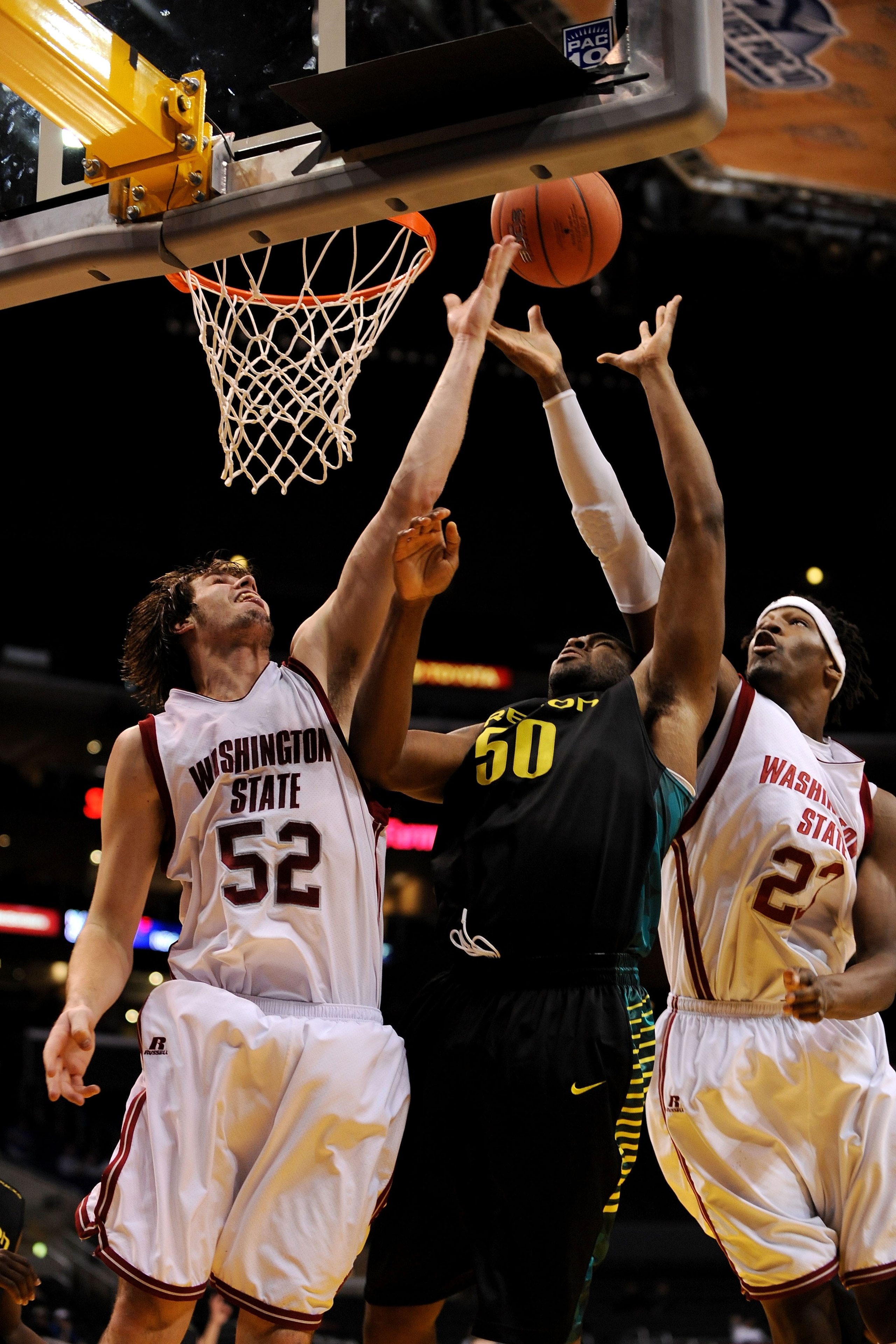 LOS ANGELES, CA - MARCH 11:  Forwards Caleb Forrest #52  and DeAngelo Casto #23 of the Washington State Cougars fight for the ball with forward Joevan Catron #50 of the Oregon Ducks during the Pacific Life Pac-10 Men's Basketball Tournament at the Staples