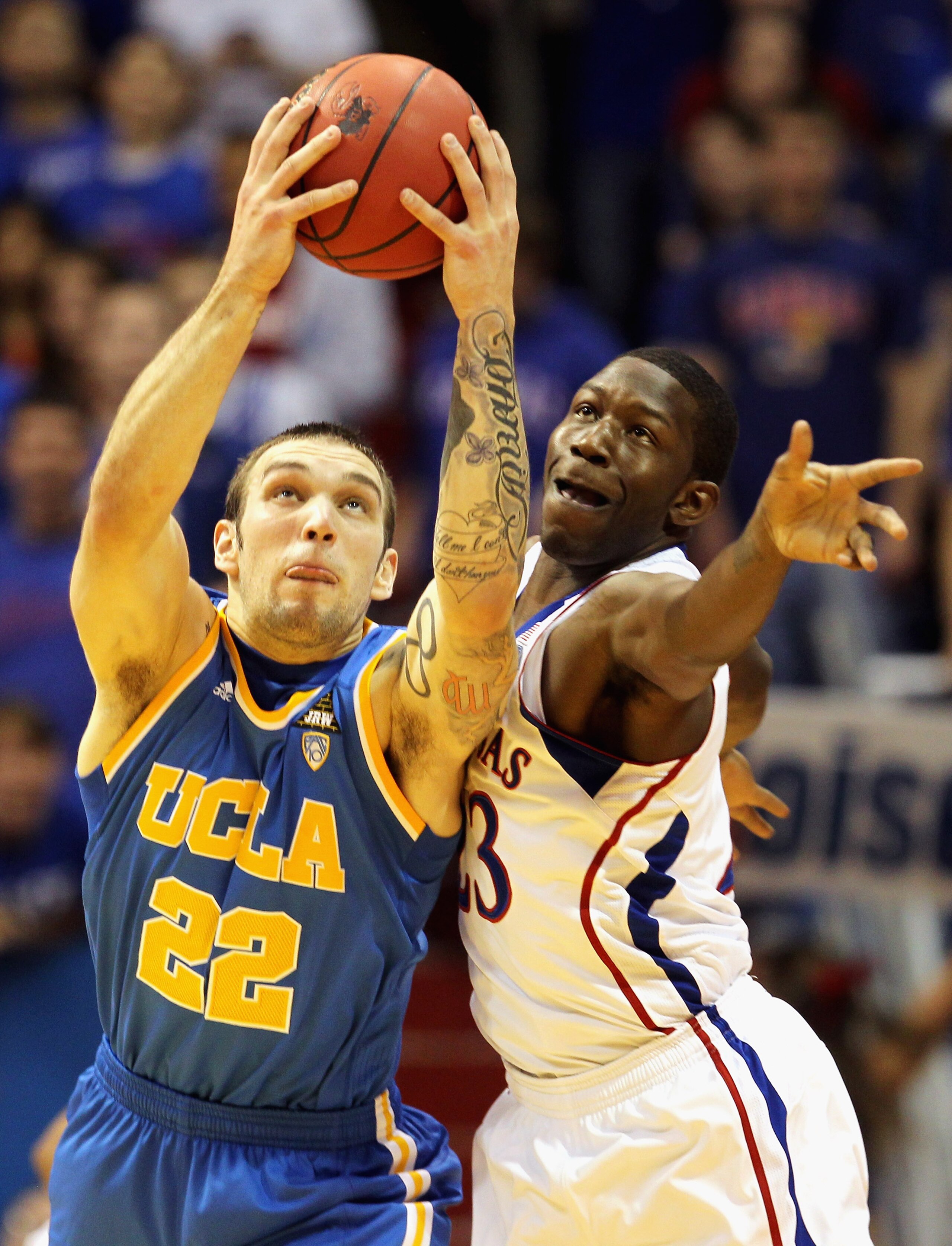 LAWRENCE, KS - DECEMBER 02:  Reeves Nelson #22 of the UCLA Bruins and Mario Little #23 of the Kansas Jayhawks battle for a loose ball during the game on December 2, 2010 at Allen Fieldhouse in Lawrence, Kansas.  (Photo by Jamie Squire/Getty Images)