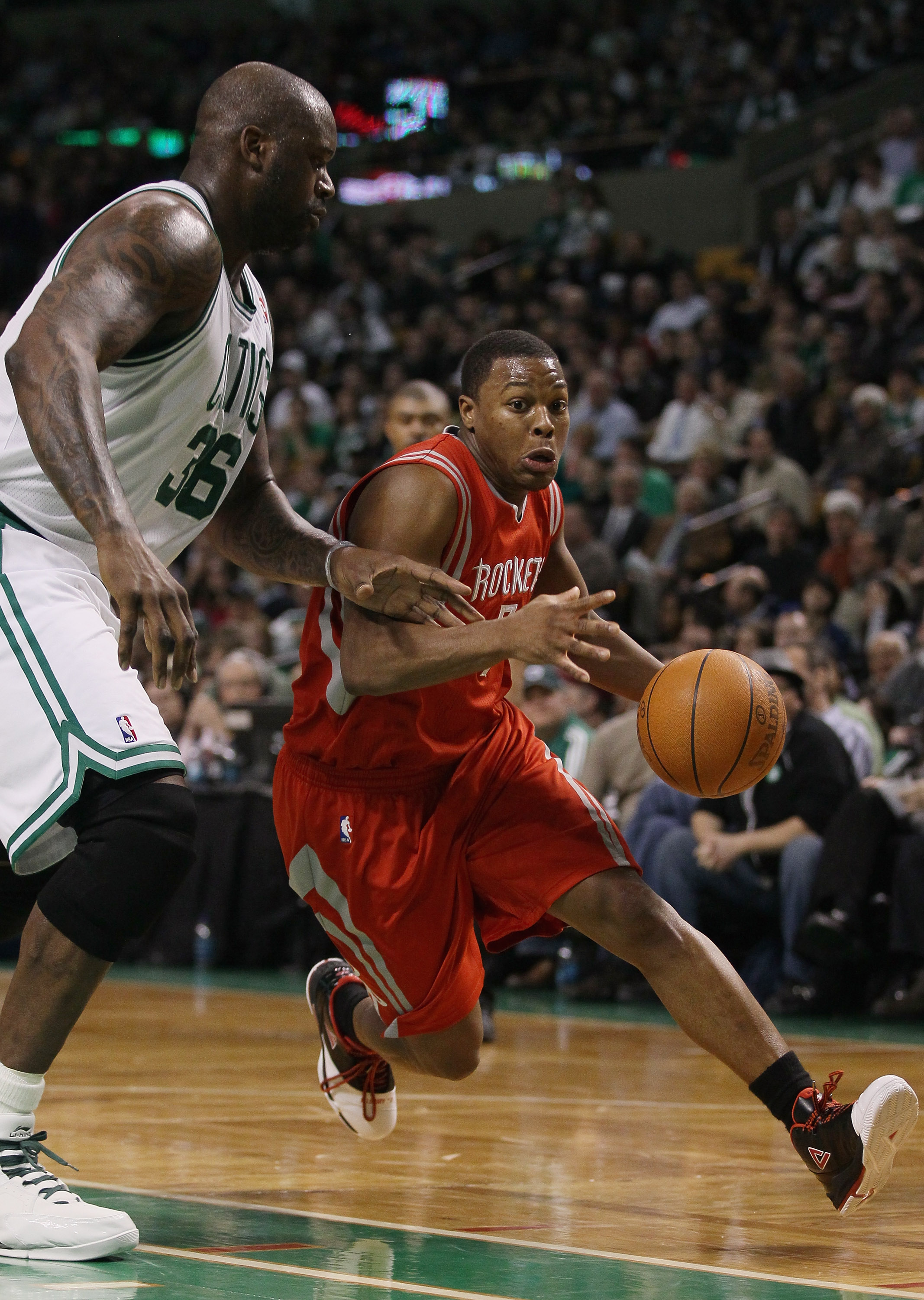 BOSTON, MA - JANUARY 10:  Kyle Lowry #7 of the Houston Rockets drives around Shaquille O'Neal #37 of the Boston Celtics on January 10, 2011 at the TD Garden in Boston, Massachusetts.  The Rockets defeated the Celtics 108-102. NOTE TO USER: User expressly