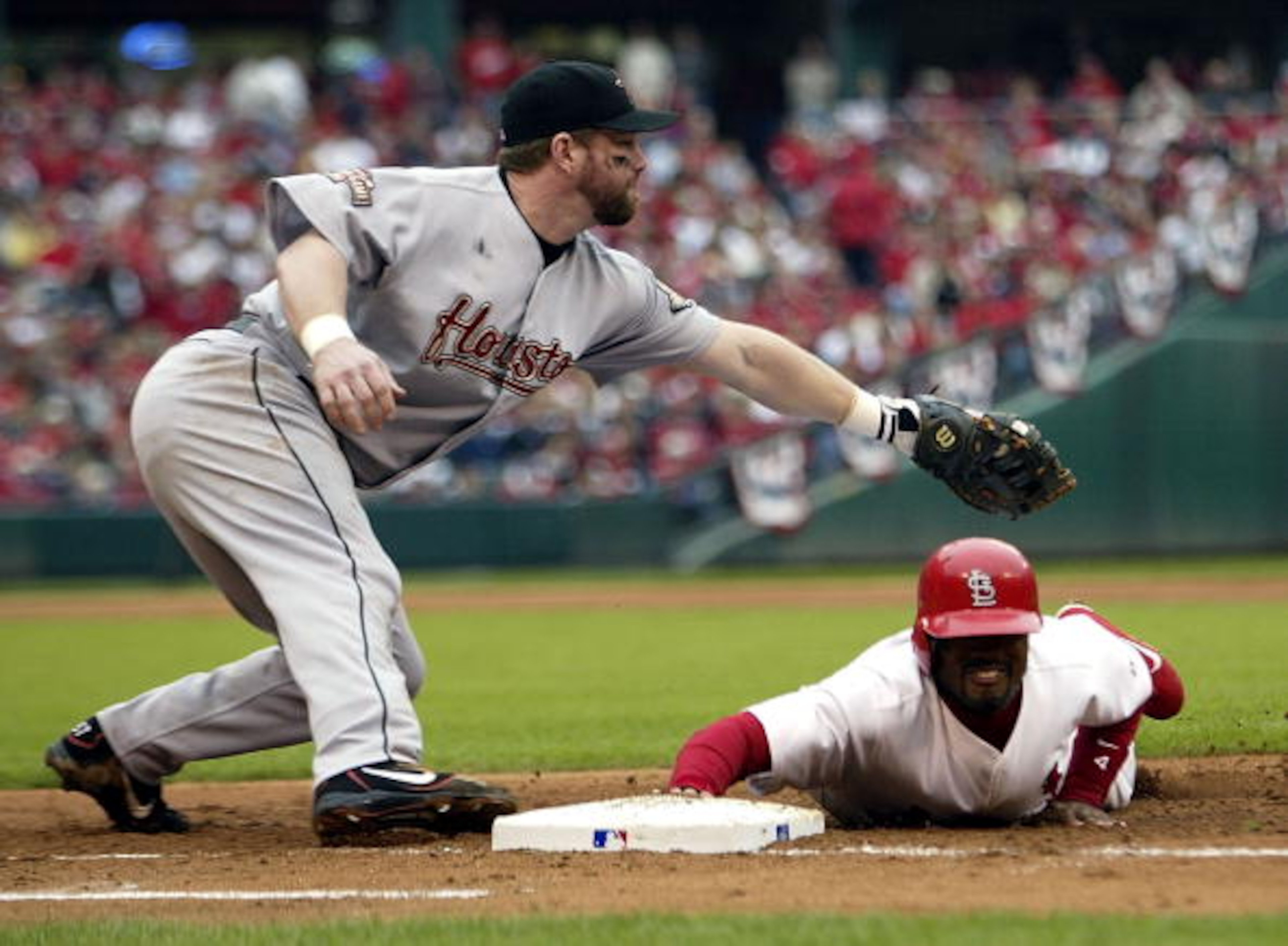 ST LOUIS - OCTOBER 20: Tony Womack #4 of the St. Louis Cardinals dives back to first under the tag from Jeff Bagwell #5 after a pick attempt in game six of the National League Championship Series on October 20, 2004 at Busch Stadium in St. Louis, Missour ST LOUIS - OCTOBER 20: Tony Womack #4 of the St. Louis Cardinals dives back to first under the tag from Jeff Bagwell #5 after a pick attempt in game six of the National League Championship Series on October 20, 2004 at Busch Stadium in St. Louis, Missour