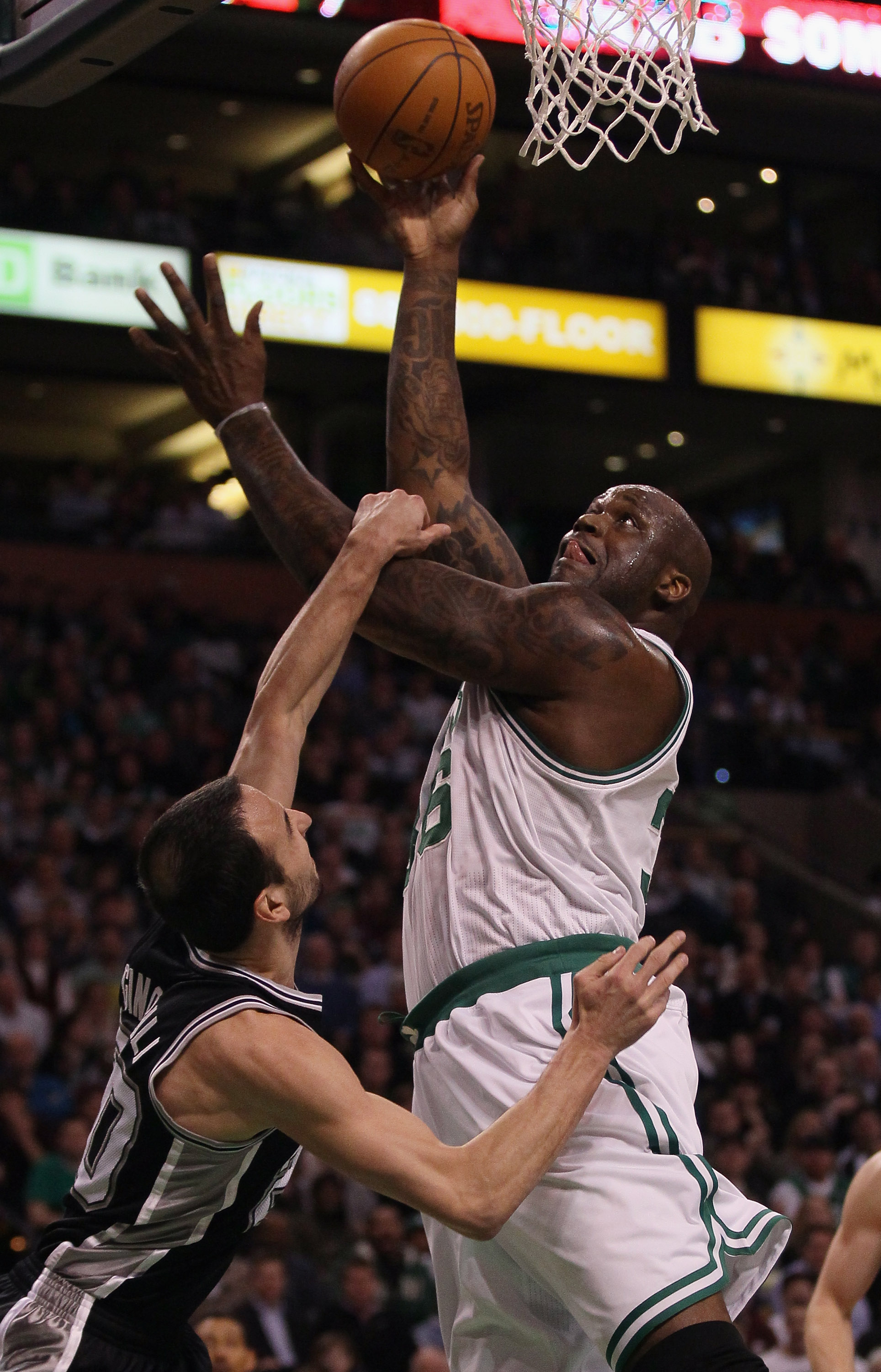 BOSTON, MA - JANUARY 05:  Shaquille O'Neal #36 of the Boston Celtics is fouled by Manu Ginobili #20 of the San Antonio Spurs on January 5, 2011 at the TD Garden in Boston, Massachusetts. NOTE TO USER: User expressly acknowledges and agrees that, by downlo