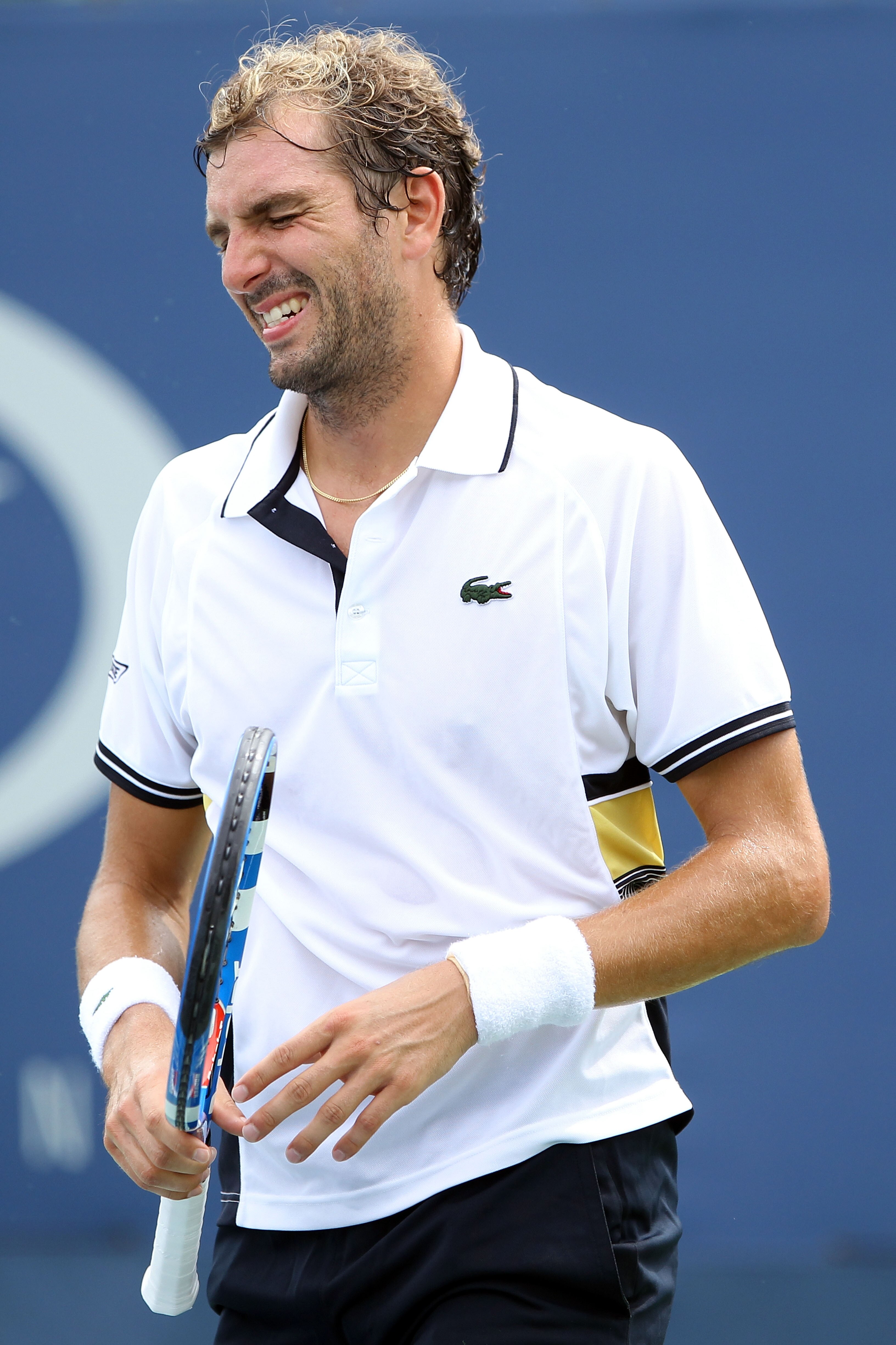 NEW YORK - SEPTEMBER 03:  Julien Benneteau of France grimaces after injuring his wrist while playing against Tommy Robredo of Spain during his men's singles match on day five of the 2010 U.S. Open at the USTA Billie Jean King National Tennis Center on Sep