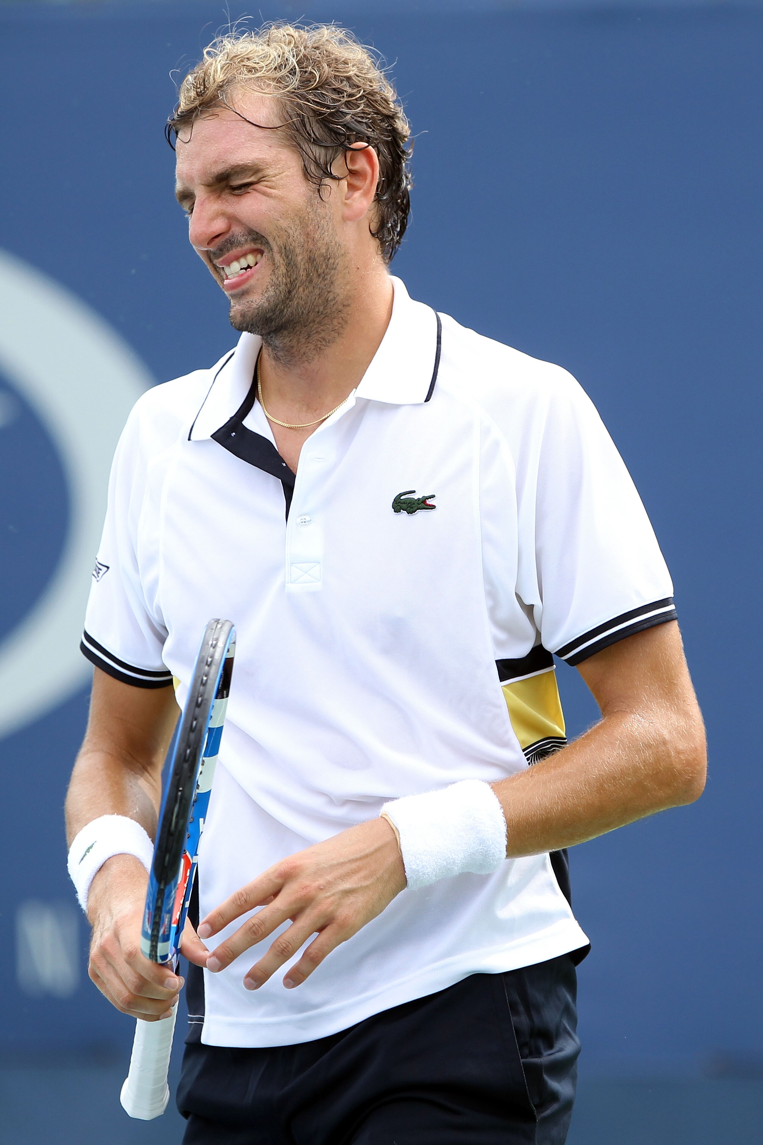 NEW YORK - SEPTEMBER 03: Julien Benneteau of France grimaces after injuring his wrist while playing against Tommy Robredo of Spain during his men's singles match on day five of the 2010 U.S. Open at the USTA Billie Jean King National Tennis Center on Sep NEW YORK - SEPTEMBER 03: Julien Benneteau of France grimaces after injuring his wrist while playing against Tommy Robredo of Spain during his men's singles match on day five of the 2010 U.S. Open at the USTA Billie Jean King National Tennis Center on Sep