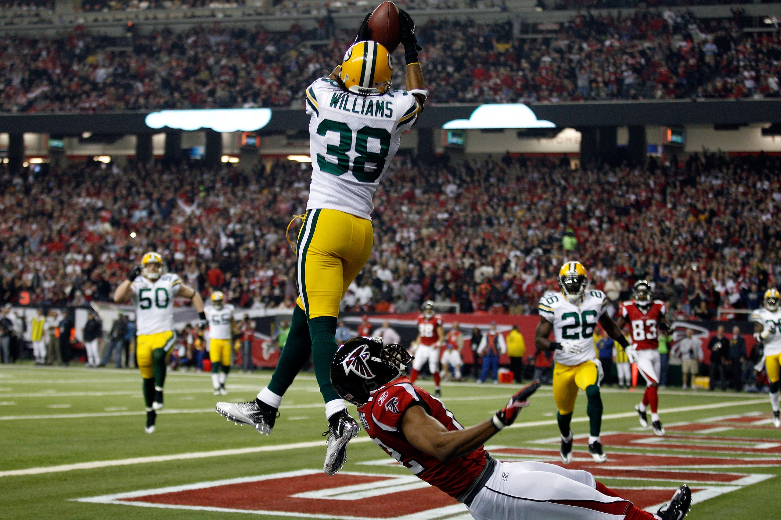 ATLANTA, GA - JANUARY 15:  Tramon Williams #38 of the Green Bay Packers intercepts a pass in the endzone against Michael Jenkins #12 of the Atlanta Falcons during their 2011 NFC divisional playoff game at Georgia Dome on January 15, 2011 in Atlanta, Georg