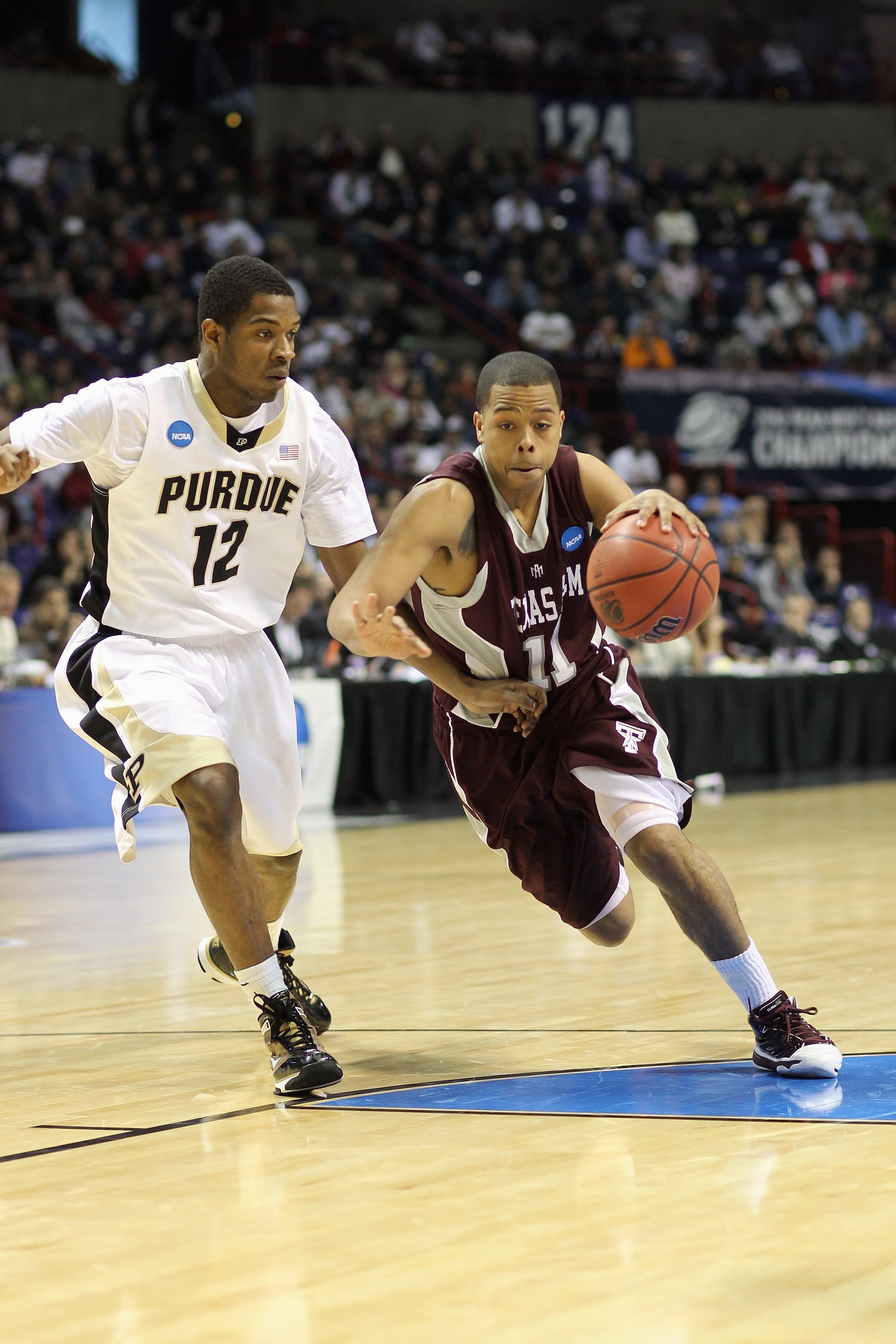 SPOKANE, WA - MARCH 21: B.J. Holmes #11 of the Texas A&M Aggies drives the ball against Kelsey Barlow #12 of the Purdue Boilermakers during the second round of the 2010 NCAA men's basketball tournament at the Spokane Arena on March 21, 2010 in Spokane, Wa
