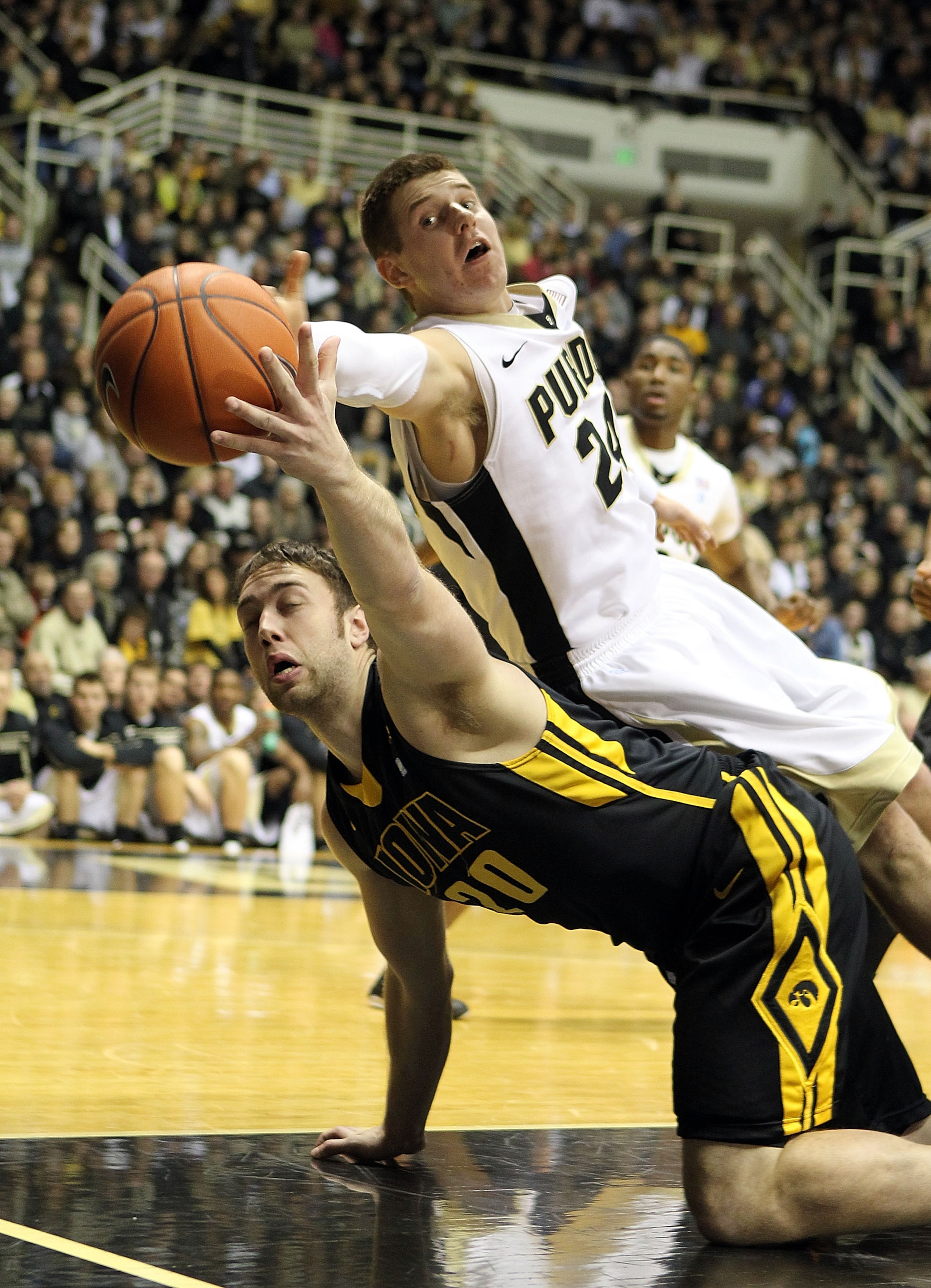 WEST LAFAYETTE, IN - JANUARY 09:  Andrew Brommer #20 of the Iowa Hawkeyes reaches for a loose ball against Ryne Smith #24 of the Purdue Boilermakers during their Big Ten Conference game at Mackey Arena on January 9, 2011 in West Lafayette, Indiana.  (Phot
