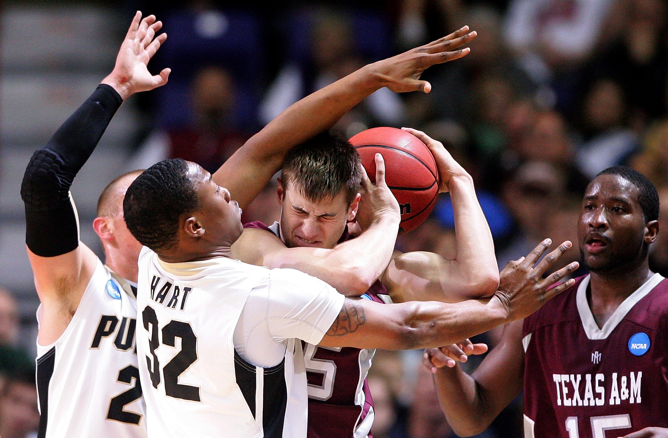 SPOKANE, WA - MARCH 21:  Nathan Walkup #45 of the Texas A&M Aggies is defended by John Hart #32 and D.J. Byrd #21 of the Purdue Boilermakers during the second round of the 2010 NCAA men's basketball tournament at Spokane Arena on March 21, 2010 in Spokane