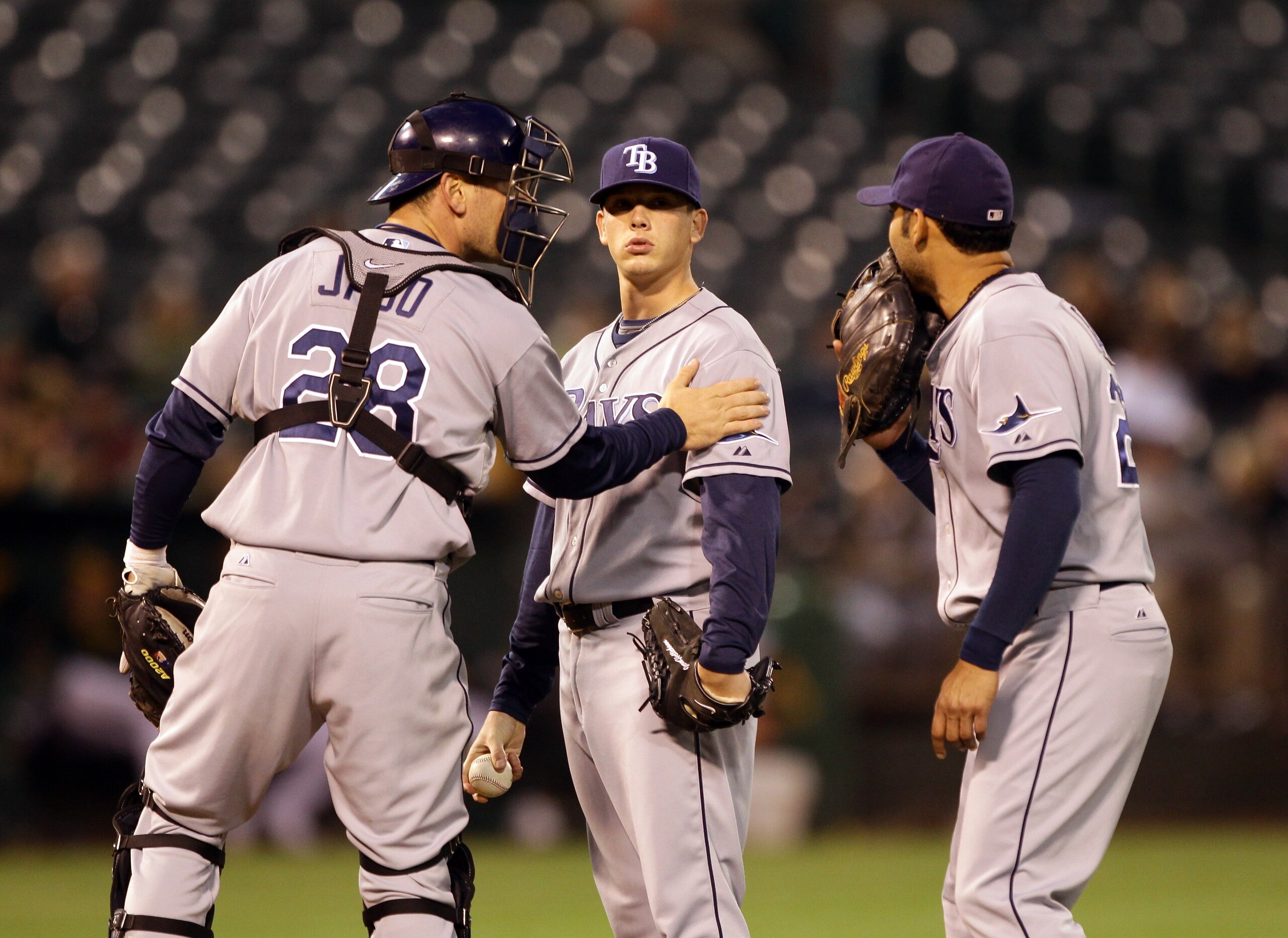 OAKLAND, CA - AUGUST 20:  John Jaso #28 and Carlos Pena #23 speak to pitcher Jeremy Hellickson #58 of the Tampa Bay Rays in the third inning of their game against the Oakland Athletics at the Oakland-Alameda County Coliseum  on August 20, 2010 in Oakland,