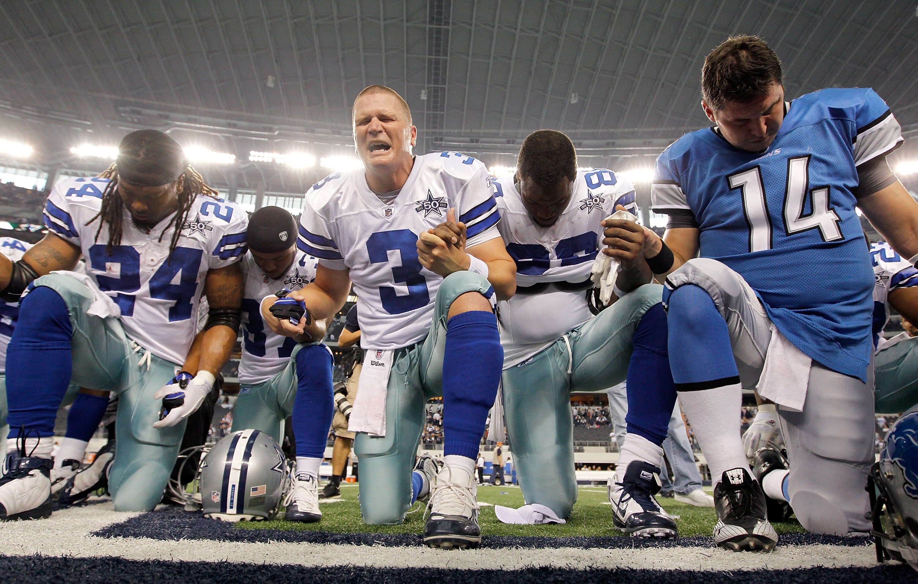 ARLINGTON, TX - NOVEMBER 21:  Quarterback Jon Kitna (C) #3 of the Dallas Cowboys leads a team prayer with running back Marion Barber #24, cornerback Bryan McCain #37, wide receiver Dez Bryant #88, and quarterback Shaun Hill #14 of the Detroit Lions at Cow