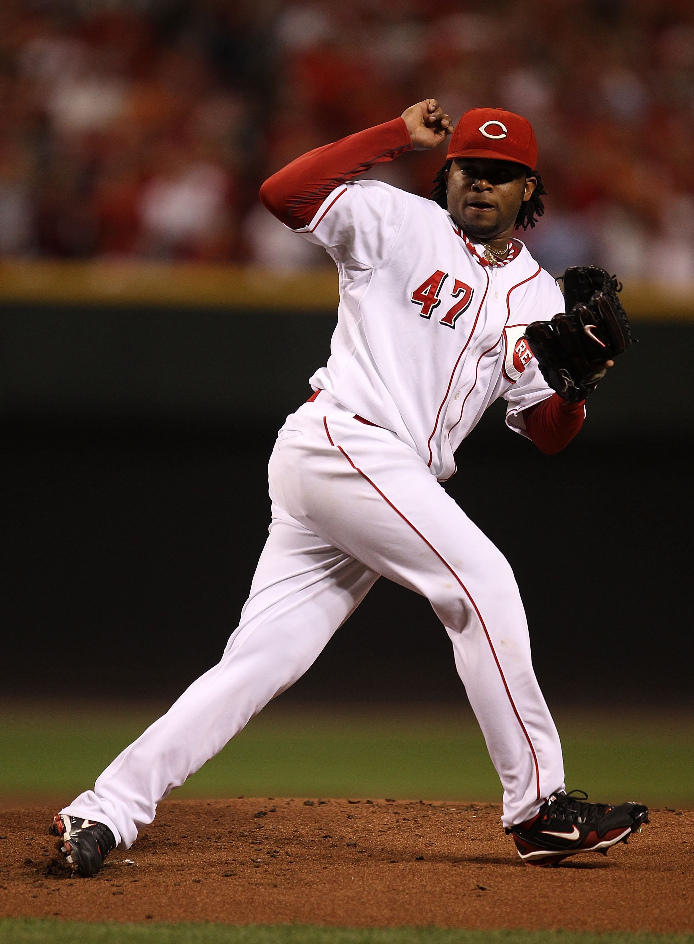 CINCINNATI - OCTOBER 10: Starting pitcher Johnny Cueto #47 of the Cincinnati Reds follows through after delivering the ball against the Philadelphia Phillies during game 3 of the NLDS at Great American Ball Park on October 10, 2010 in Cincinnati, Ohio.  T