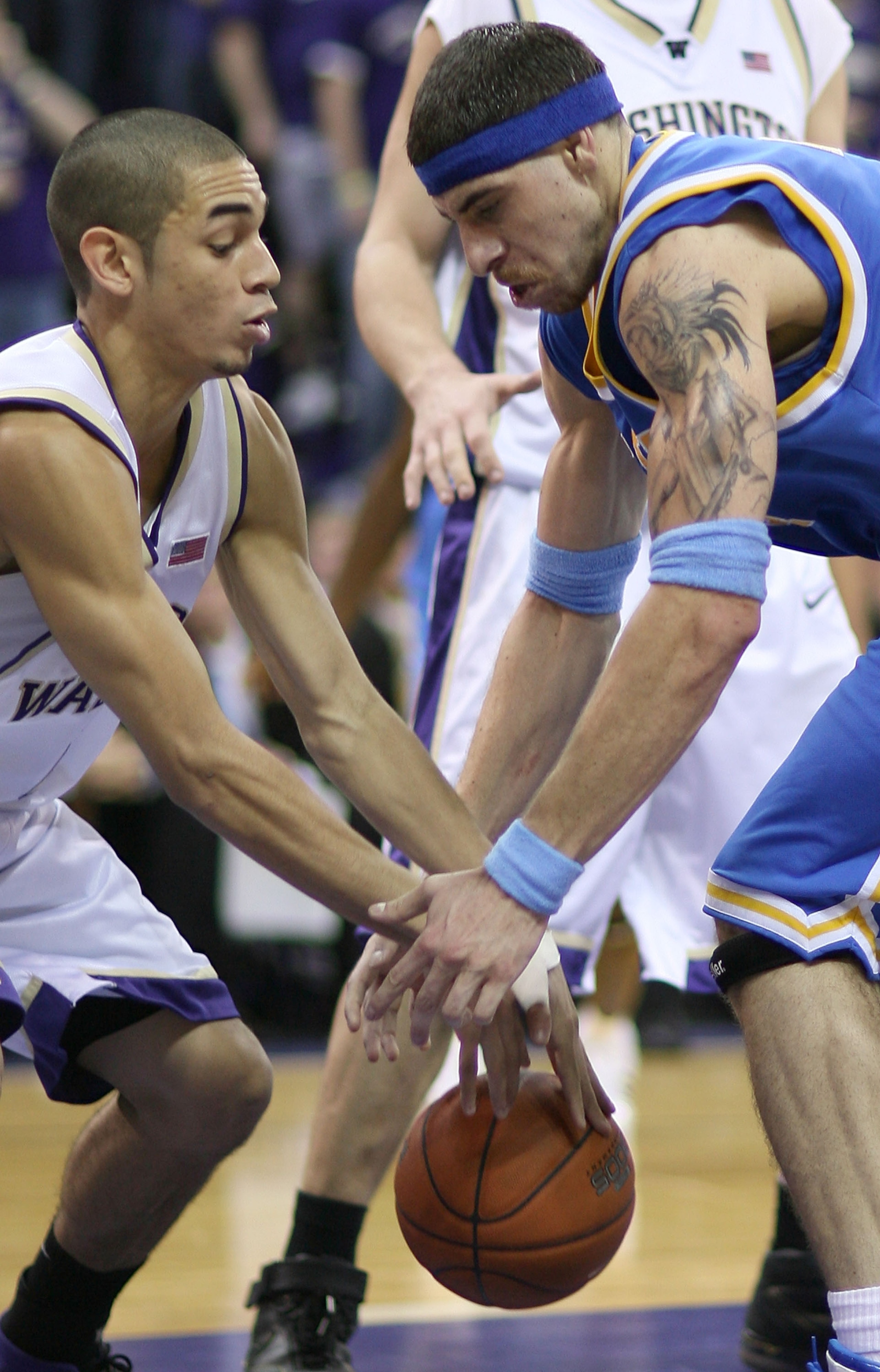 SEATTLE - MARCH 3:  Lorenzo Mata #14  (R) of the UCLA Bruins fights for the ball  against Adrian Oliver #2 of the Washington Huskies at Edmundson Pavilion March 3, 2007 in Seattle, Washington. The Huskies defeated the Bruins 61-51.  (Photo by Otto Greule