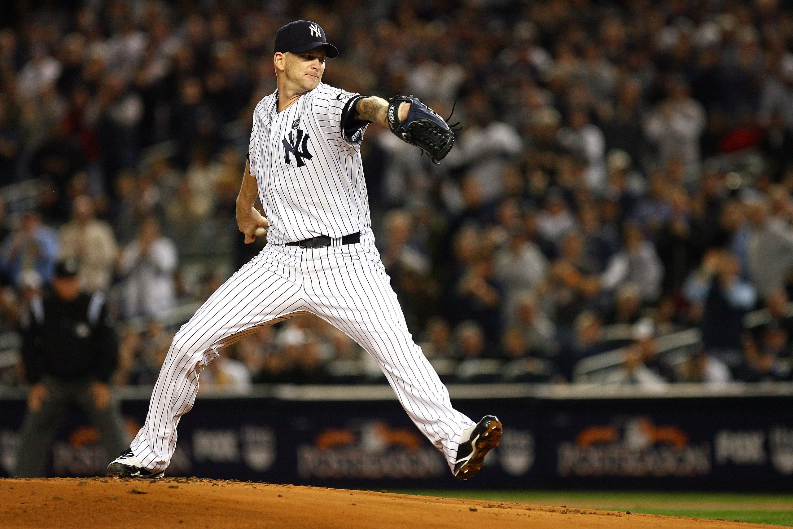 NEW YORK - OCTOBER 19:  A.J. Burnett #34 of the New York Yankees pitches against the Texas Rangers in Game Four of the ALCS during the 2010 MLB Playoffs at Yankee Stadium on October 19, 2010 in the Bronx borough of New York City. The Rangers won 10-3.  (P