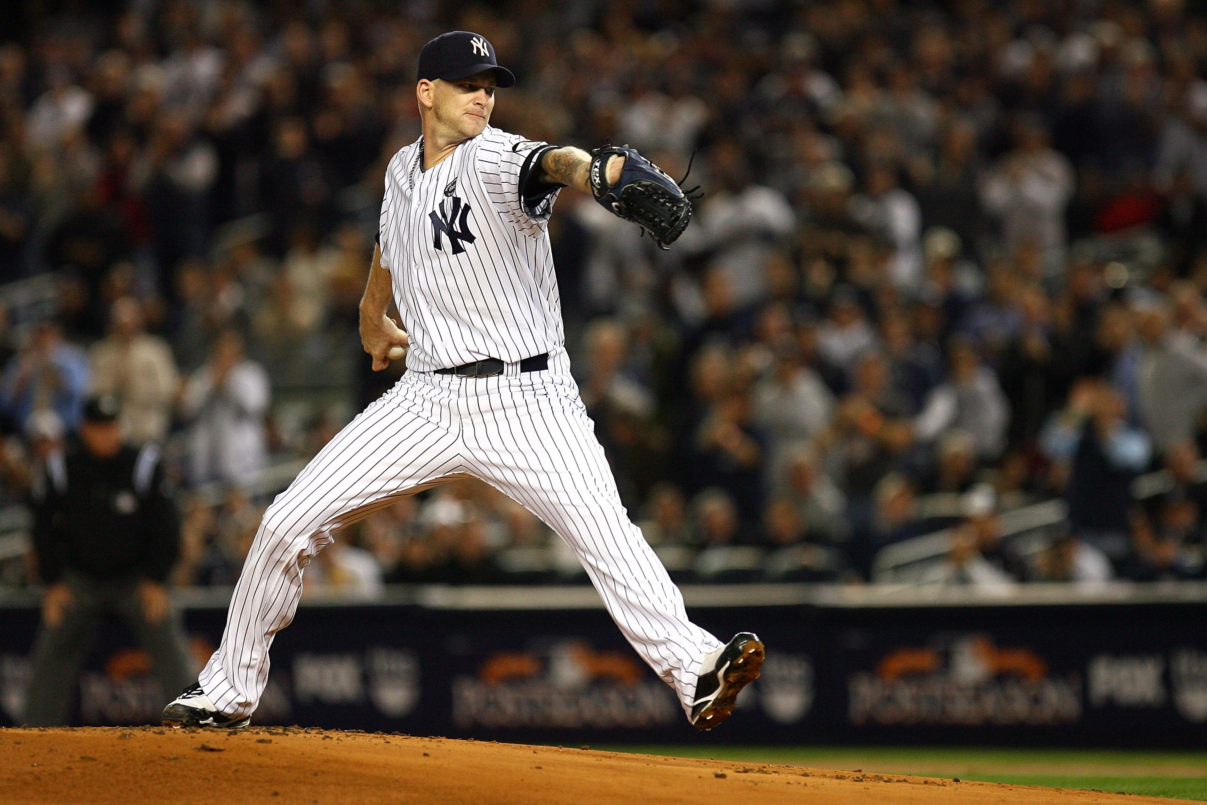 NEW YORK - OCTOBER 19:  A.J. Burnett #34 of the New York Yankees pitches against the Texas Rangers in Game Four of the ALCS during the 2010 MLB Playoffs at Yankee Stadium on October 19, 2010 in the Bronx borough of New York City. The Rangers won 10-3.  (P