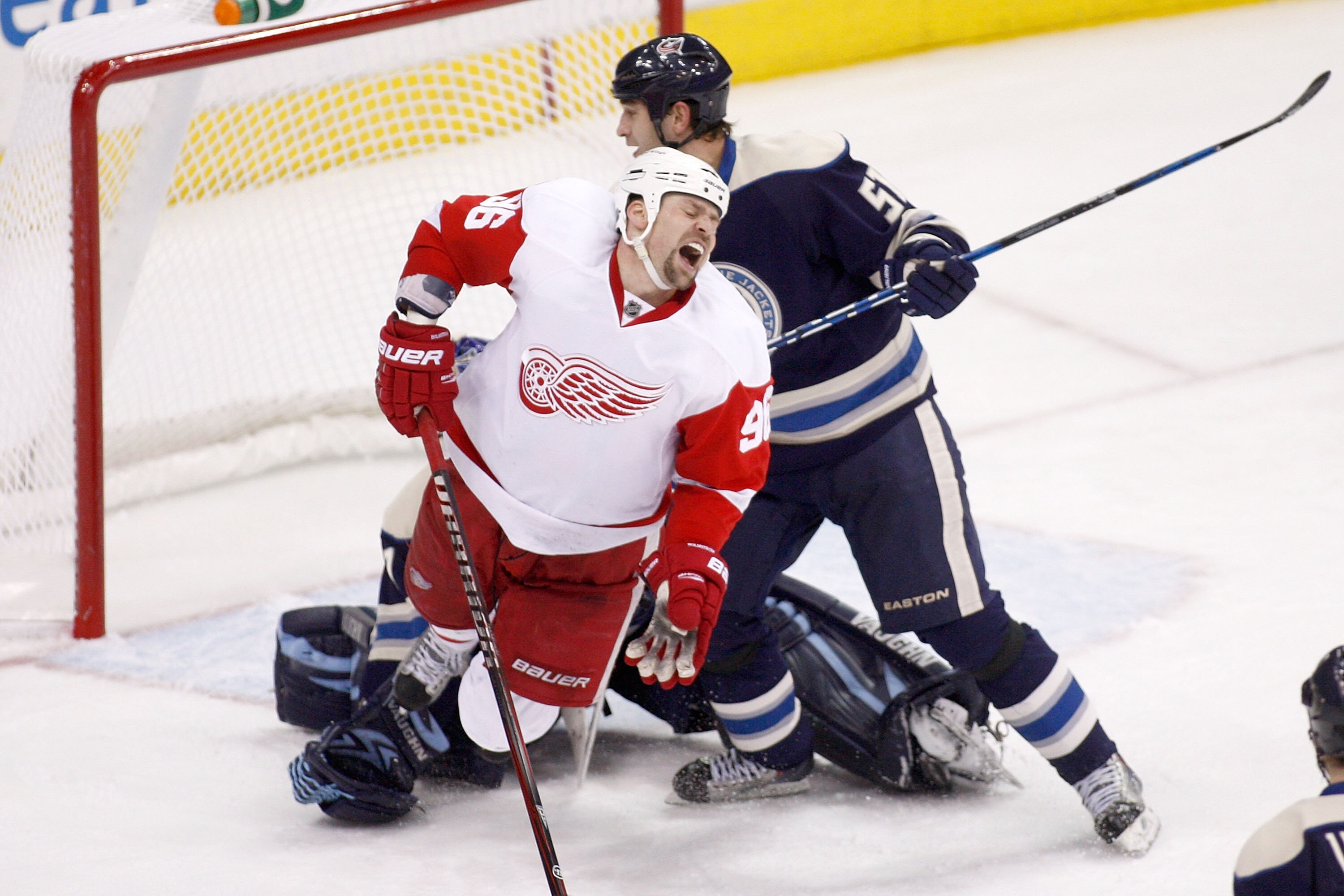 COLUMBUS, OH - JANUARY 14:  Fedor Tyutin #51 of the Columbus Blue Jackets checks Tomas Holmstrom #96 of the Detroit Red Wings during the third period on January 14, 2011 at Nationwide Arena in Columbus, Ohio. Columbus defeated Detroit 3-2 in a shootout. (