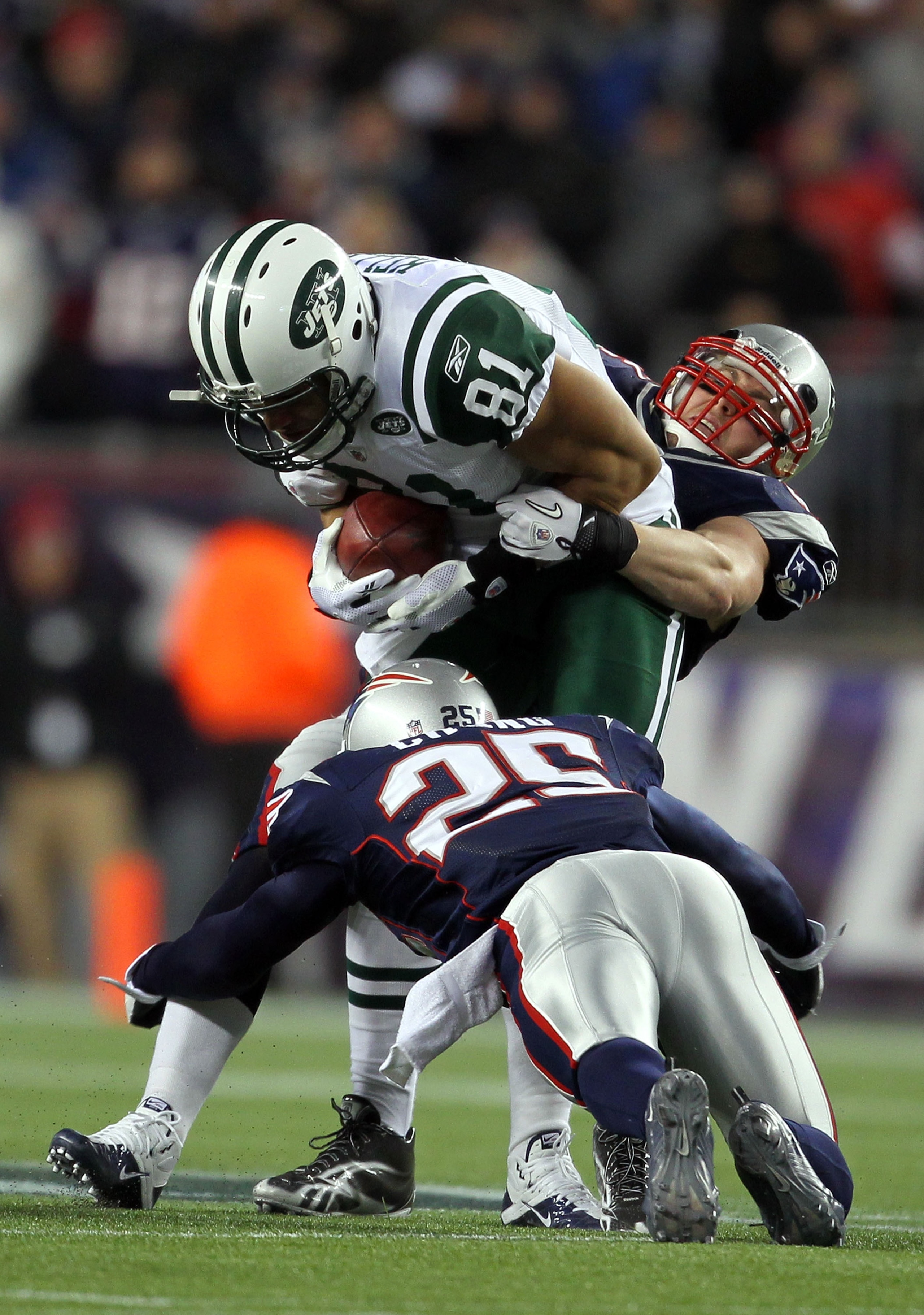 FOXBORO, MA - JANUARY 16:  Dustin Keller #81 of the New York Jets is tackled short of the first down by Pat Chung #25 of the New England Patriots and Dane Fletcher #52 of the New England Patriots during their 2011 AFC divisional playoff game at Gillette S