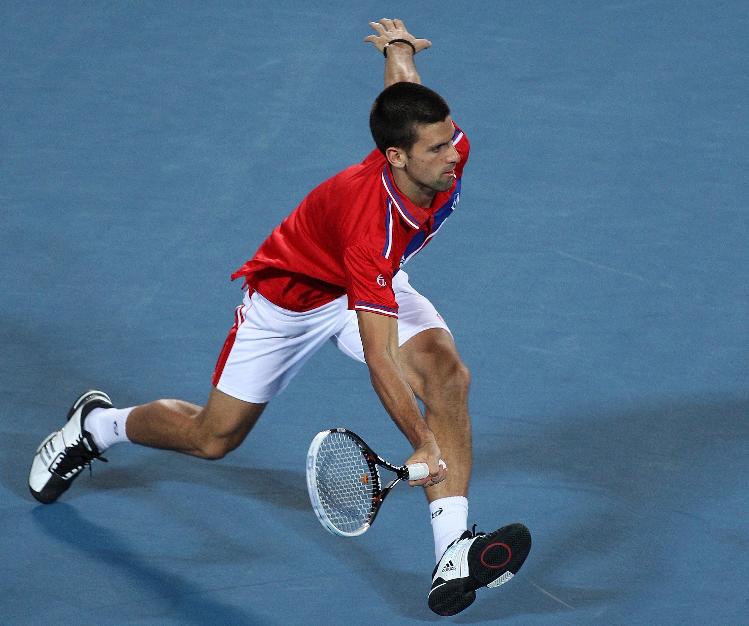 PERTH, AUSTRALIA - JANUARY 06: Novak Djokovic of Serbia plays a return shot during his mixed doubles match against Justine Henin and Ruben Bemelmans of Belgium on day six of the Hopman Cup at The Burswood Dome on January 6, 2011 in Perth, Australia. (Ph PERTH, AUSTRALIA - JANUARY 06: Novak Djokovic of Serbia plays a return shot during his mixed doubles match against Justine Henin and Ruben Bemelmans of Belgium on day six of the Hopman Cup at The Burswood Dome on January 6, 2011 in Perth, Australia. (Ph