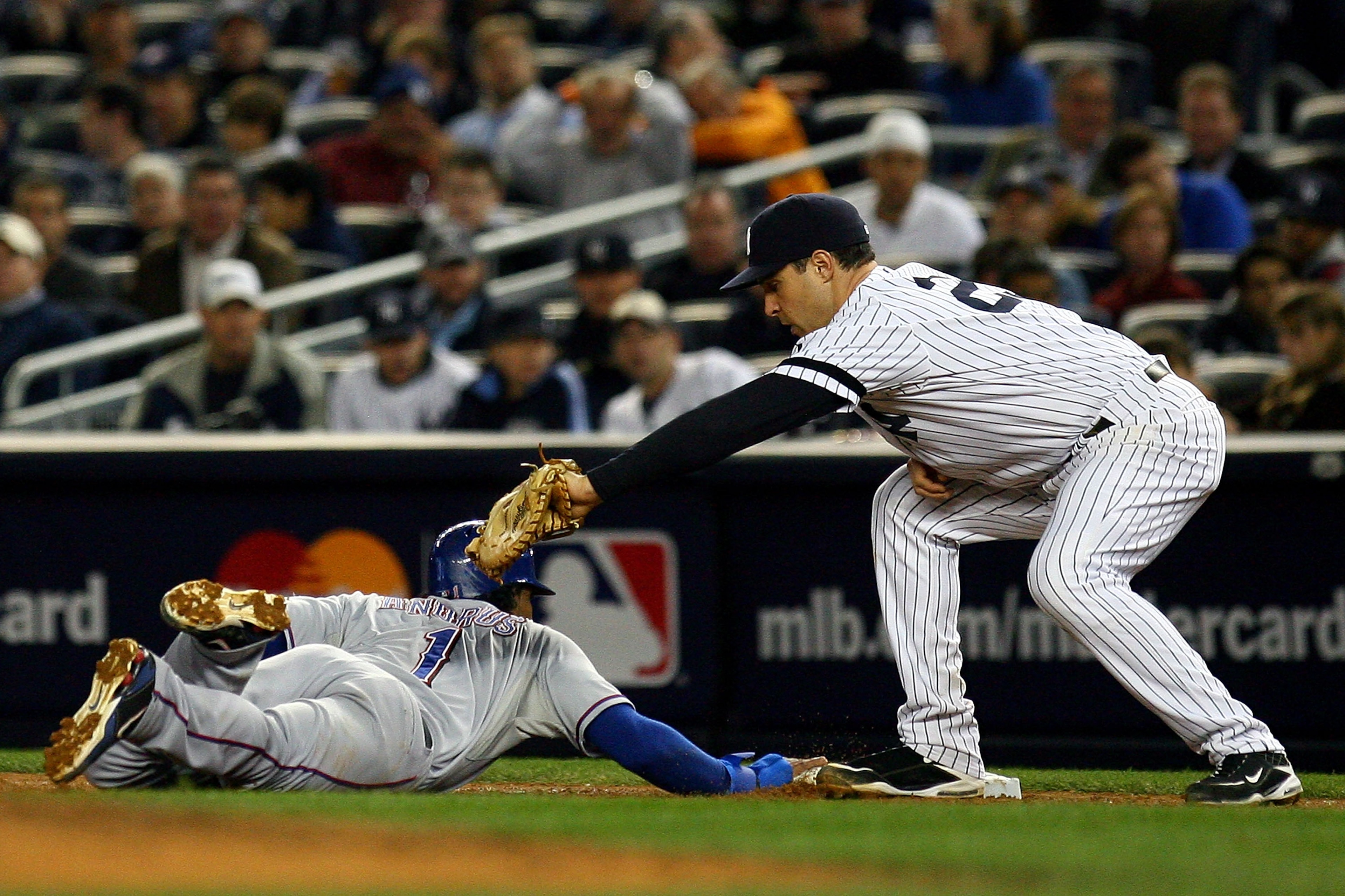 NEW YORK - OCTOBER 19: Elvis Andrus #1 of the Texas Rangers slides safely into first under the tag of Mark Teixeira #25 of the New York Yankees in Game Four of the ALCS during the 2010 MLB Playoffs at Yankee Stadium on October 19, 2010 in the Bronx borou NEW YORK - OCTOBER 19: Elvis Andrus #1 of the Texas Rangers slides safely into first under the tag of Mark Teixeira #25 of the New York Yankees in Game Four of the ALCS during the 2010 MLB Playoffs at Yankee Stadium on October 19, 2010 in the Bronx borou