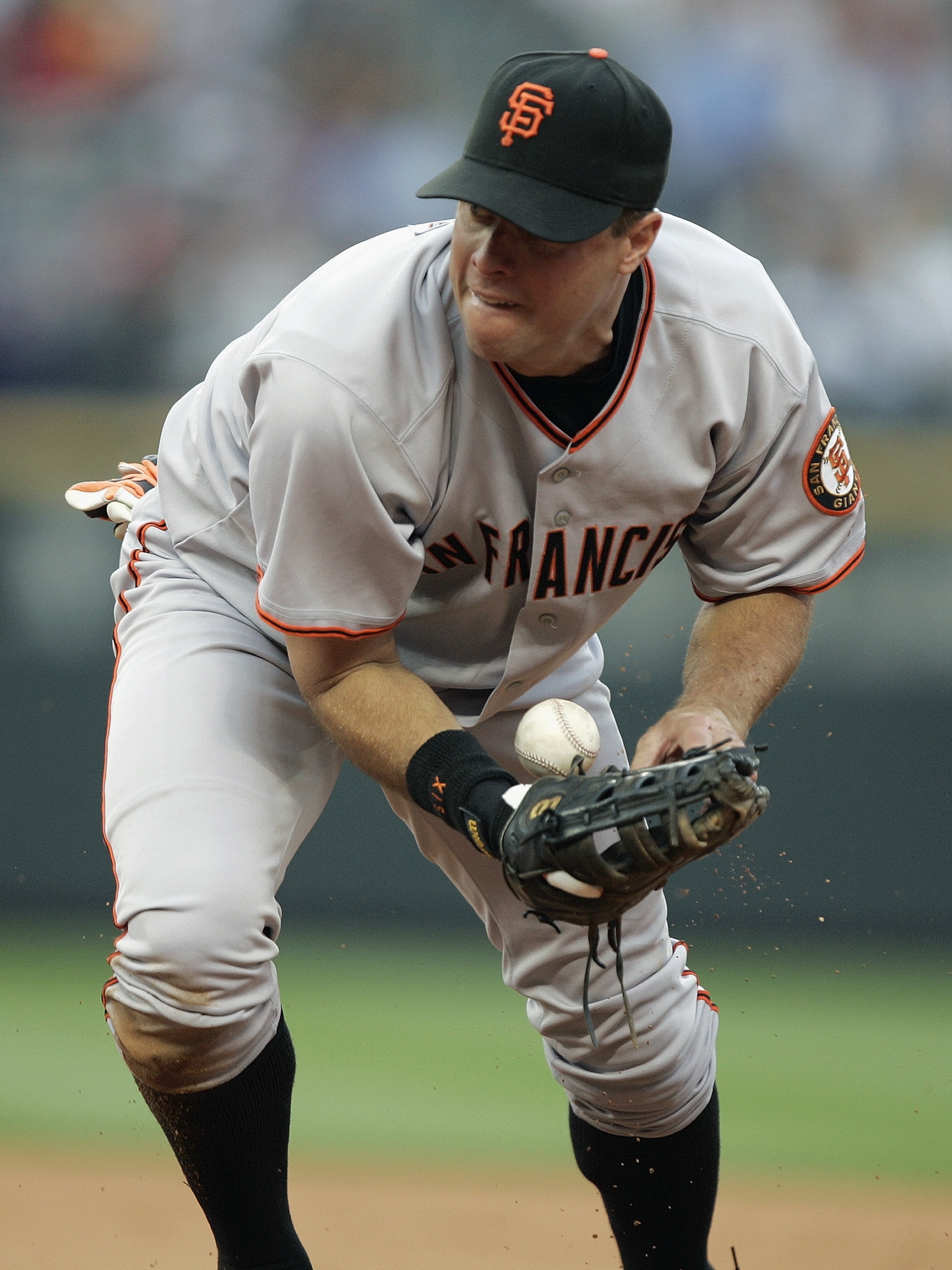 DENVER - JULY 17:  First baseman J.T. Snow #6 of the San Francisco Giants fields the ball during the game against the Colorado Rockies at Coors Field on July 17, 2004 in Denver, Colorado.  The Giants won 4-0. (Photo by Brian Bahr/Getty Images)