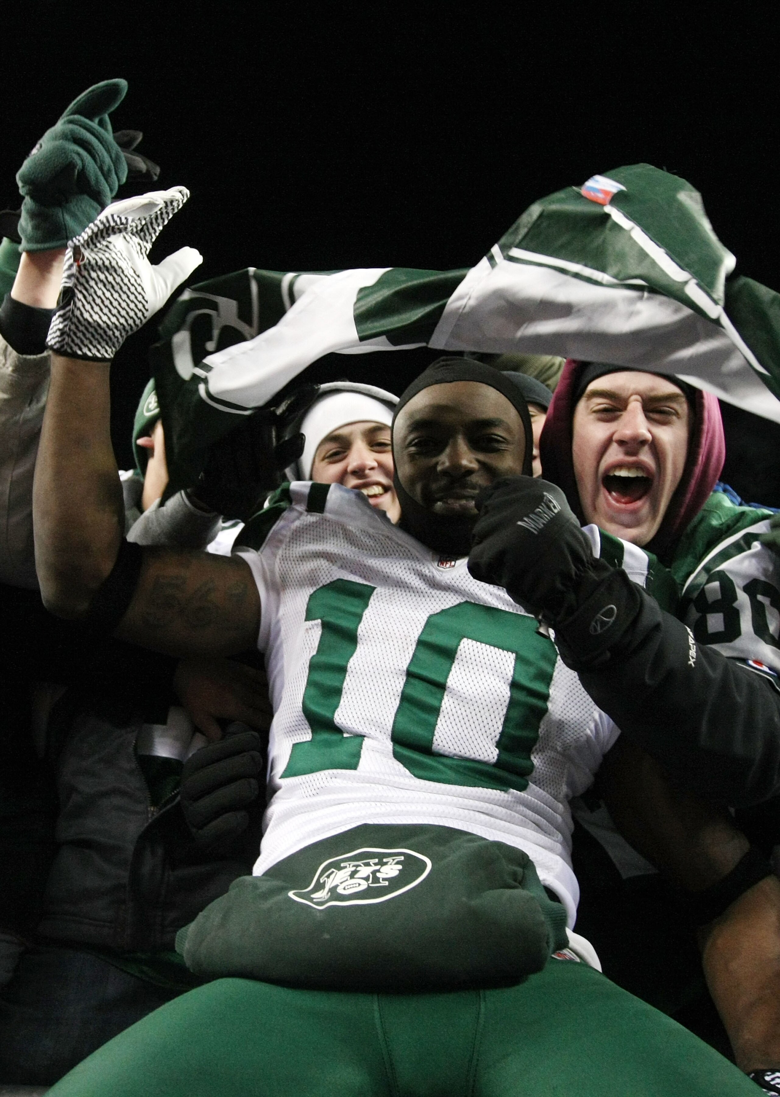FOXBORO, MA - JANUARY 16: Santonio Holmes #10 of the New York Jets celebrates with fans after the Jets defeated the Patriots 28 to 21 in their 2011 AFC divisional playoff game at Gillette Stadium on January 16, 2011 in Foxboro, Massachusetts. (Photo by FOXBORO, MA - JANUARY 16: Santonio Holmes #10 of the New York Jets celebrates with fans after the Jets defeated the Patriots 28 to 21 in their 2011 AFC divisional playoff game at Gillette Stadium on January 16, 2011 in Foxboro, Massachusetts. (Photo by