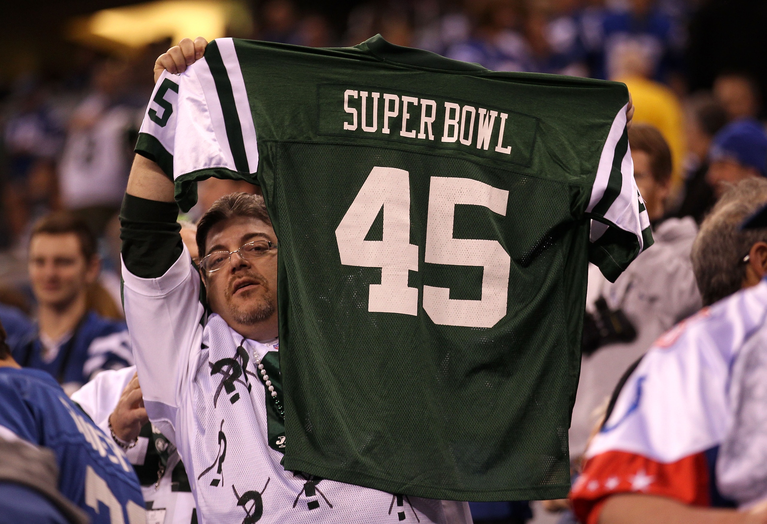 INDIANAPOLIS, IN - JANUARY 08: A fan of the New York Jets holds up a Jets Jersey which reads 'Super Bowl 45' against the Indianapolis Colts during their 2011 AFC wild card playoff game at Lucas Oil Stadium on January 8, 2011 in Indianapolis, Indiana. The INDIANAPOLIS, IN - JANUARY 08: A fan of the New York Jets holds up a Jets Jersey which reads 'Super Bowl 45' against the Indianapolis Colts during their 2011 AFC wild card playoff game at Lucas Oil Stadium on January 8, 2011 in Indianapolis, Indiana. The