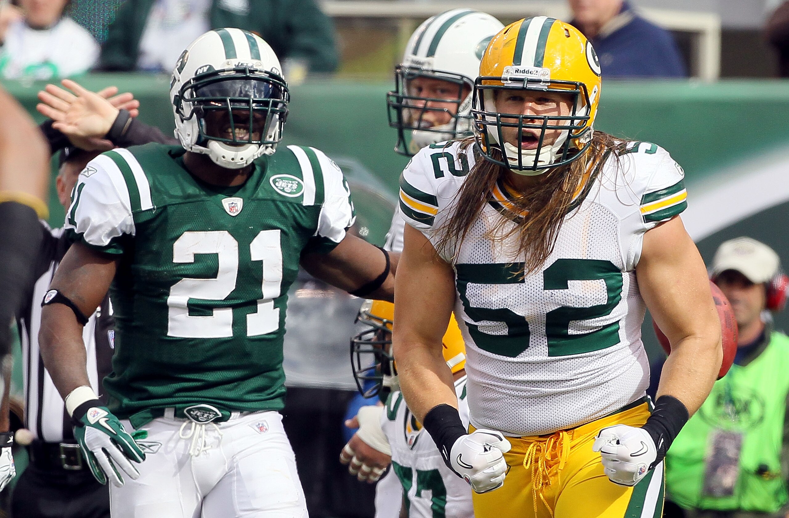 EAST RUTHERFORD, NJ - OCTOBER 31: Clay Matthews #52 of the Green Bay Packers celebrates a play as LaDainian Tomlinson #21 of the New York Jets looks on on October 31, 2010 at the New Meadowlands Stadium in East Rutherford, New Jersey. (Photo by Jim McIs EAST RUTHERFORD, NJ - OCTOBER 31: Clay Matthews #52 of the Green Bay Packers celebrates a play as LaDainian Tomlinson #21 of the New York Jets looks on on October 31, 2010 at the New Meadowlands Stadium in East Rutherford, New Jersey. (Photo by Jim McIs