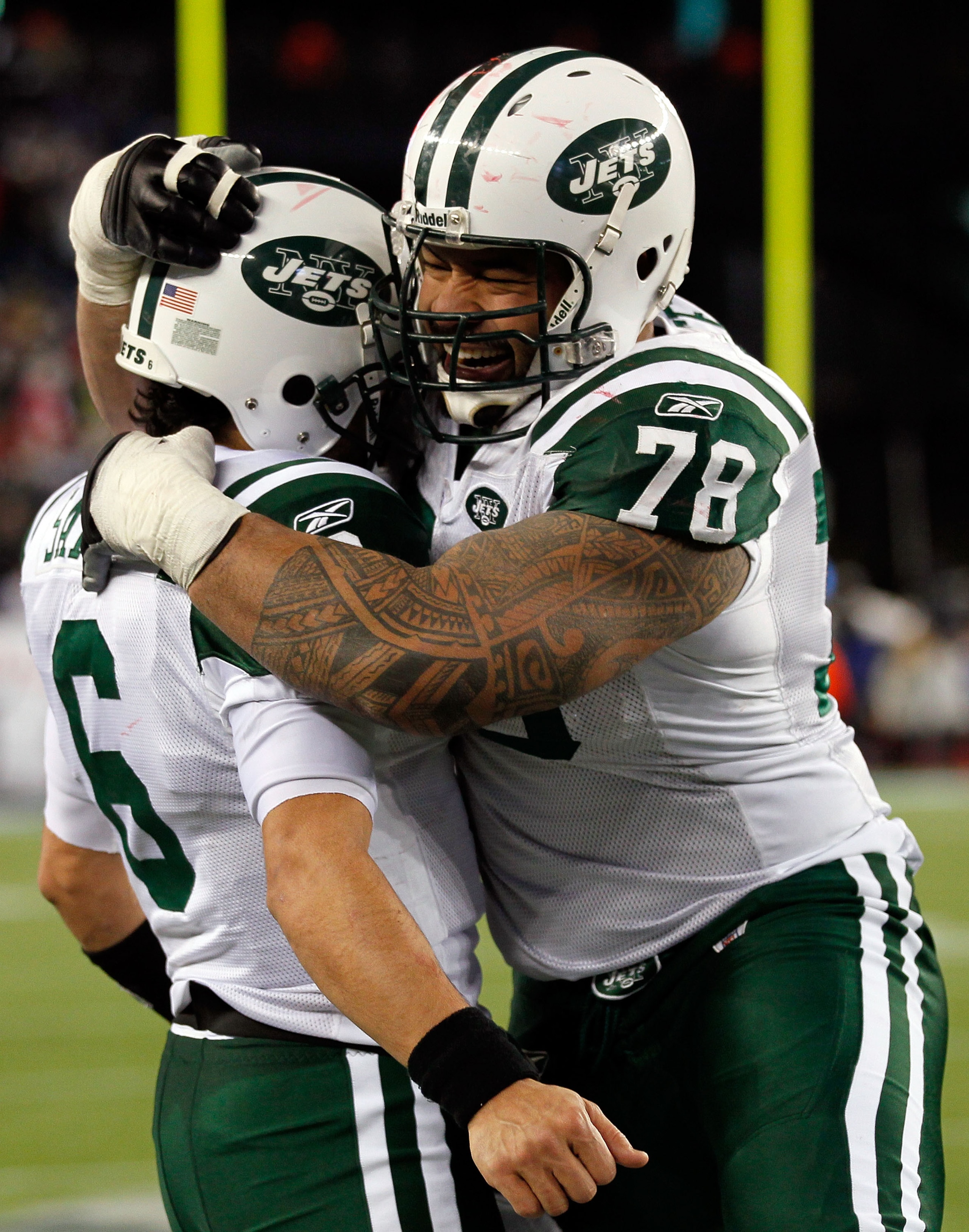 FOXBORO, MA - JANUARY 16:  Mark Sanchez #6 of the New York Jets and Wayne Hunter #78 celebrate on their way to defeating the New England Patriots 28 to 21 victory over the New England Patriots during their 2011 AFC divisional playoff game at Gillette Stad