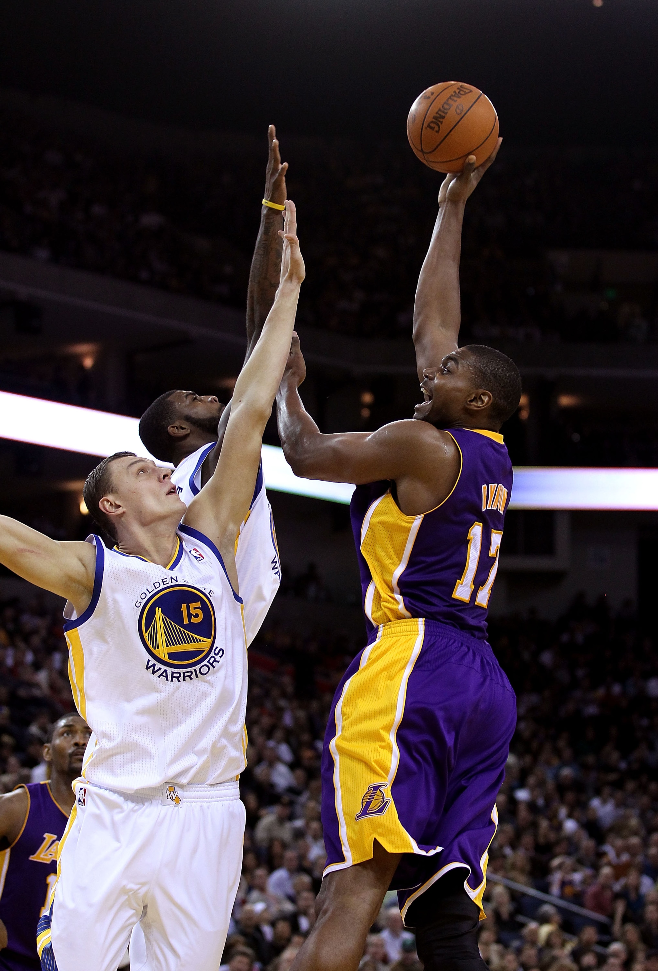 OAKLAND, CA - JANUARY 12: Andrew Bynum #17 of the Los Angeles Lakers shoots over Andris Biedrins #15 of the Golden State Warriors at Oracle Arena on January 12, 2011 in Oakland, California. NOTE TO USER: User expressly acknowledges and agrees that, by dow