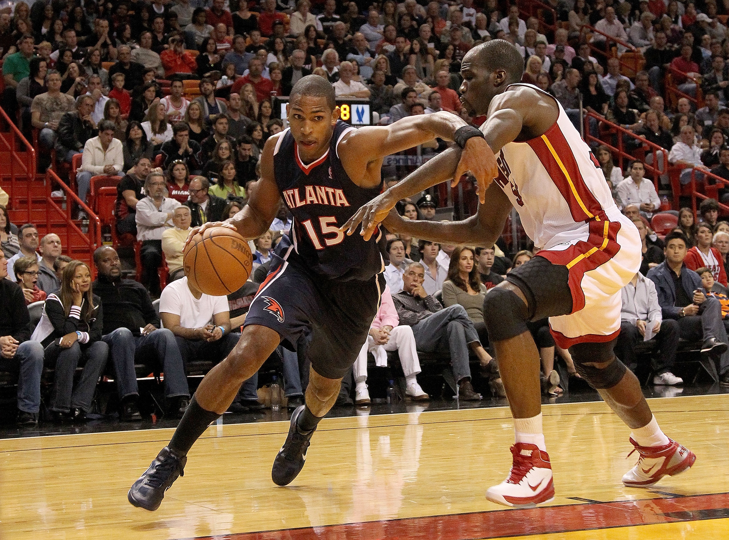 MIAMI, FL - DECEMBER 04:  Al Horford #15 of the Atlanta Hawks drives to the basket against Joel Anthony #50 of the Miami Heat during a game at American Airlines Arena on December 4, 2010 in Miami, Florida. NOTE TO USER: User expressly acknowledges and agr