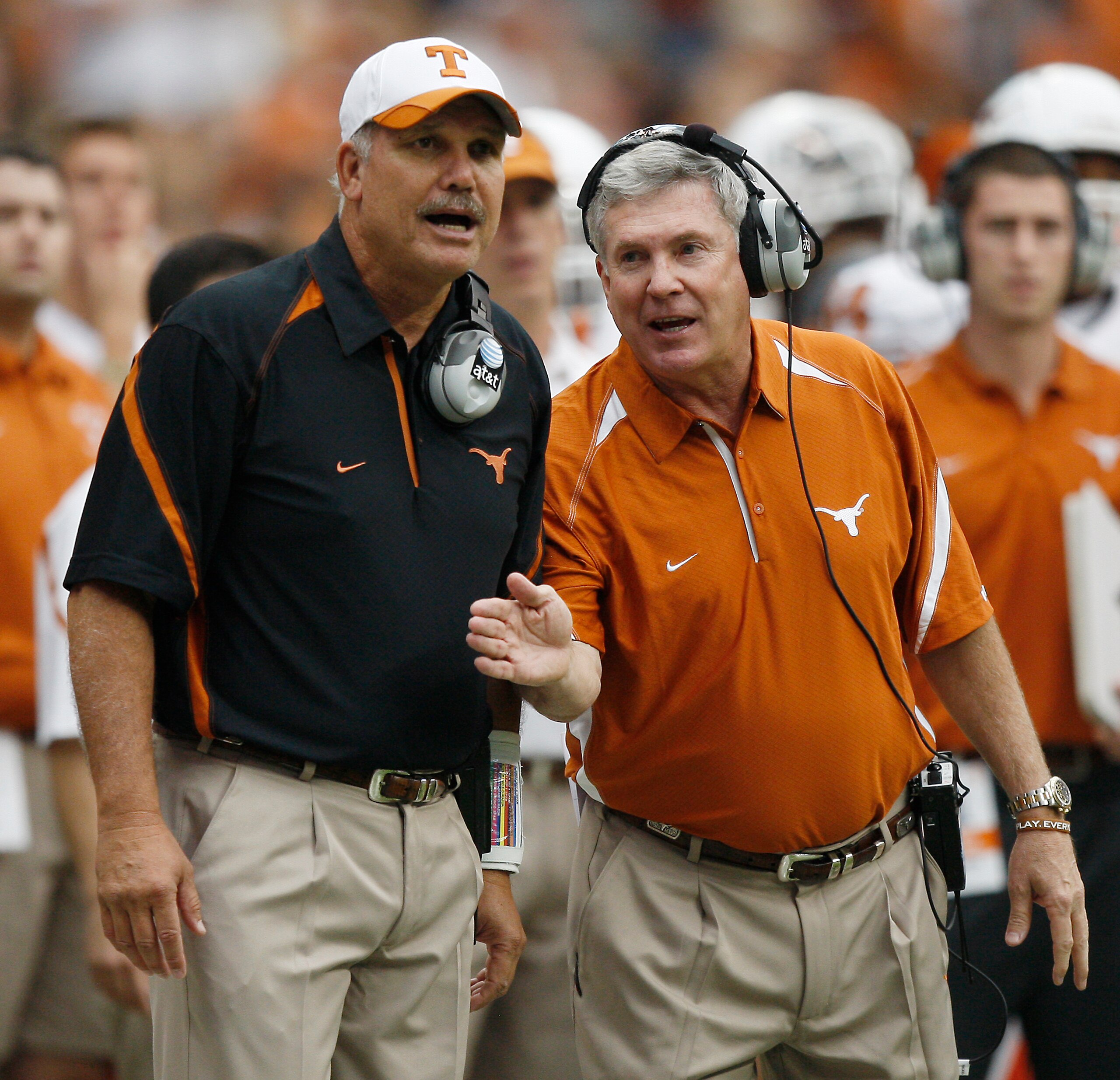 HOUSTON - SEPTEMBER 04:  Head coach Mack Brown, right, and assistant head coach Duane Akina chat on the sidelines during a game against the Rice Owls at Reliant Stadium on September 4, 2010 in Houston, Texas.  (Photo by Bob Levey/Getty Images)