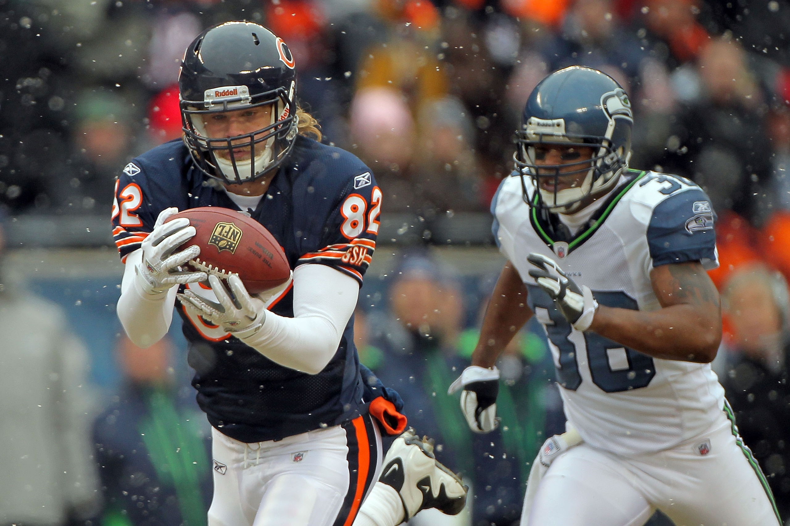 CHICAGO, IL - JANUARY 16:  Tight end Greg Olsen #82 of the Chicago Bears catches a 58-yard touchdown in the first quarter in front of Lawyer Milloy #36 of the Seattle Seahawks in the 2011 NFC divisional playoff game at Soldier Field on January 16, 2011 in