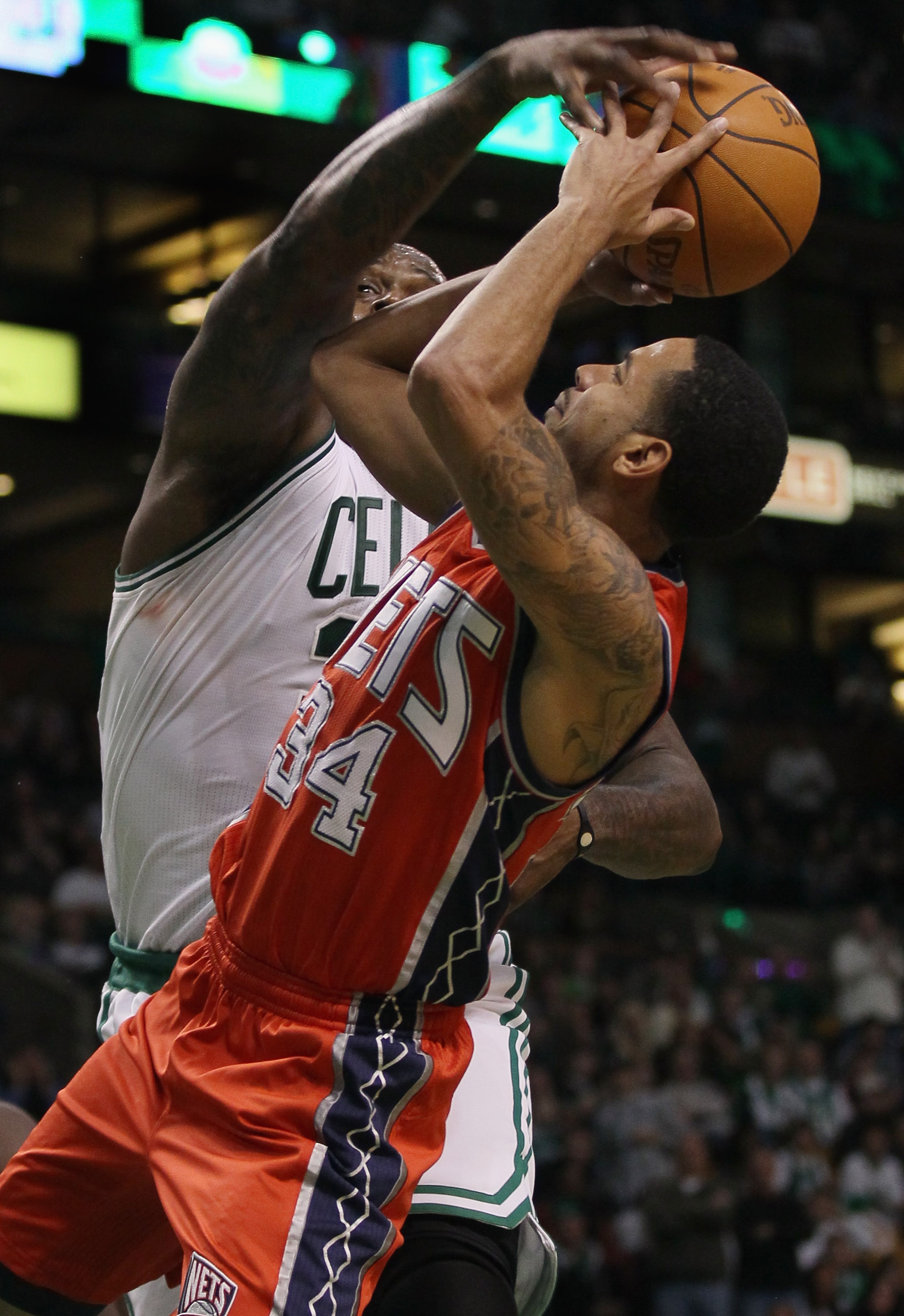 BOSTON - NOVEMBER 24:  Shaquille O'Neal #36 of the Boston Celtics blocks a shot by Devin Harris #34 of the New Jersey Nets on November 24, 2010 at the TD Garden in Boston, Massachusetts. The Celtics defeated the nets 89-83. NOTE TO USER: User expressly ac