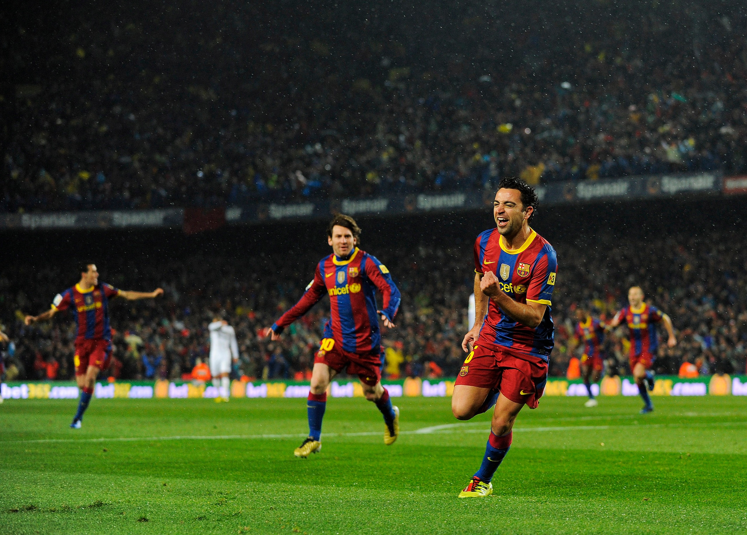 BARCELONA, SPAIN - NOVEMBER 29: Xavi Hernandez of Barcelona celebrates after scoring the first goal during the La Liga match between Barcelona and Real Madrid at the Camp Nou Stadium on November 29, 2010 in Barcelona, Spain. Barcelona won the match 5-0. BARCELONA, SPAIN - NOVEMBER 29: Xavi Hernandez of Barcelona celebrates after scoring the first goal during the La Liga match between Barcelona and Real Madrid at the Camp Nou Stadium on November 29, 2010 in Barcelona, Spain. Barcelona won the match 5-0.