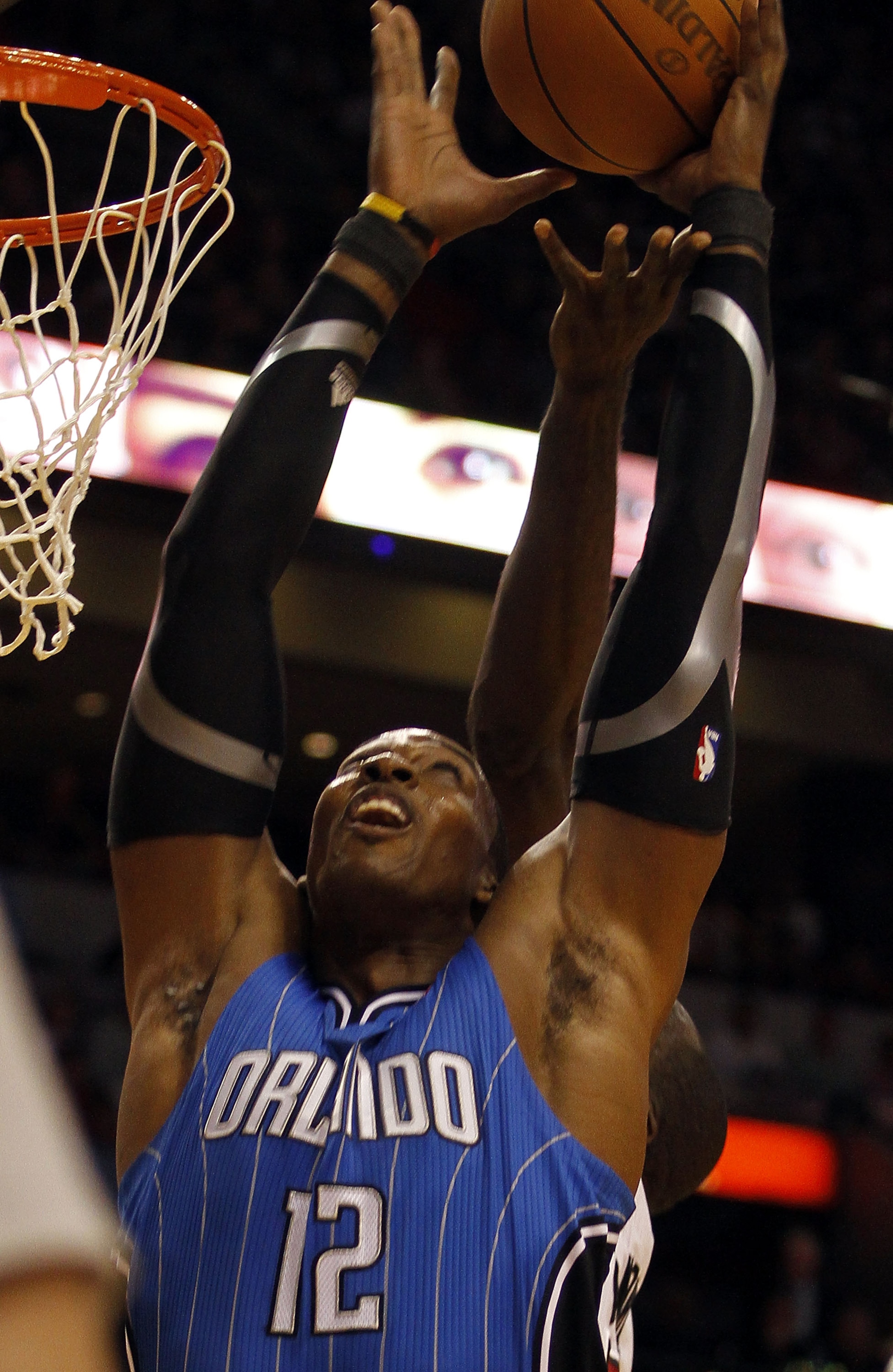 MIAMI - OCTOBER 29:  Center Dwight Howard #12  of the Orlando Magic dunks against the Miami Heat at American Airlines Arena on October 29, 2010 in Miami, Florida.  NOTE TO USER: User expressly acknowledges and agrees that, by downloading and or using this