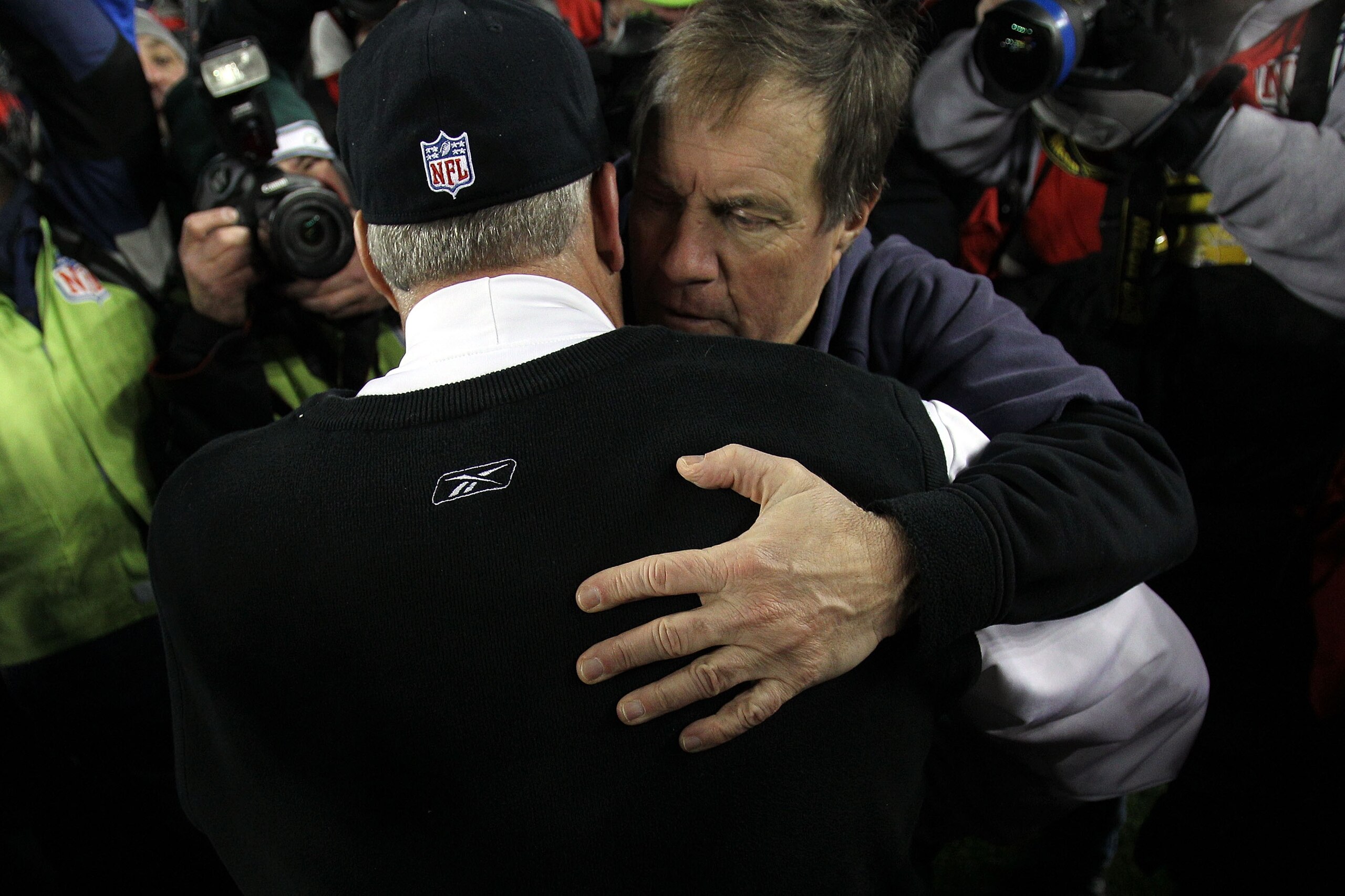 FOXBORO, MA - JANUARY 16:  Head coach Rex Ryan of the New York Jets hugs head coach Bill Belichick of the New England Patriots after the Jets defeated the Patriots 28 to 21 during their 2011 AFC divisional playoff game at Gillette Stadium on January 16, 2