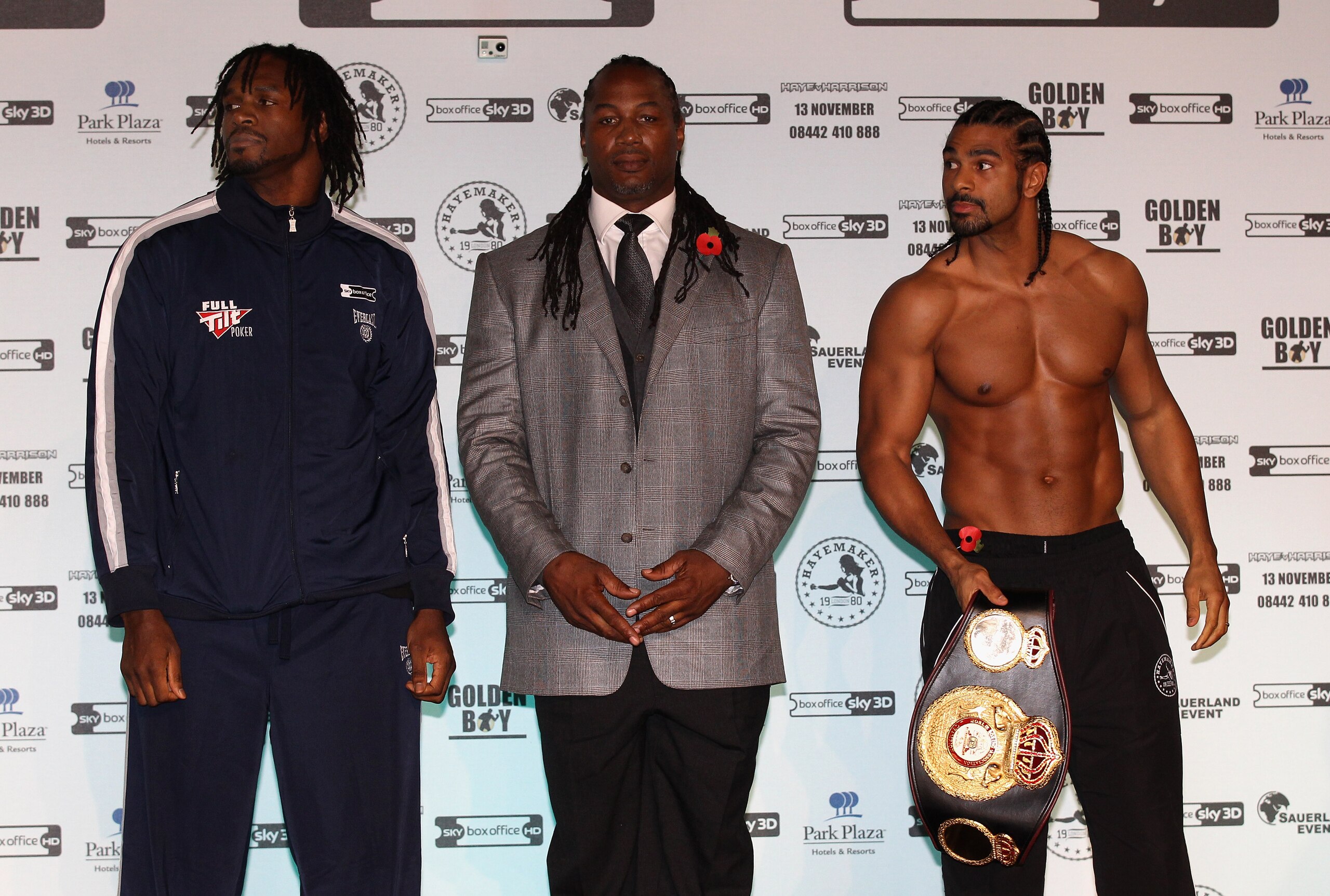 MANCHESTER, ENGLAND - NOVEMBER 12:  Former heavyweight champion of the world, Lennox Lewis, steps in between David Haye and Audley Harrison as they go face to face during the official weigh-in at The Lowry Theatre on November 12, 2010 in Manchester, Engla