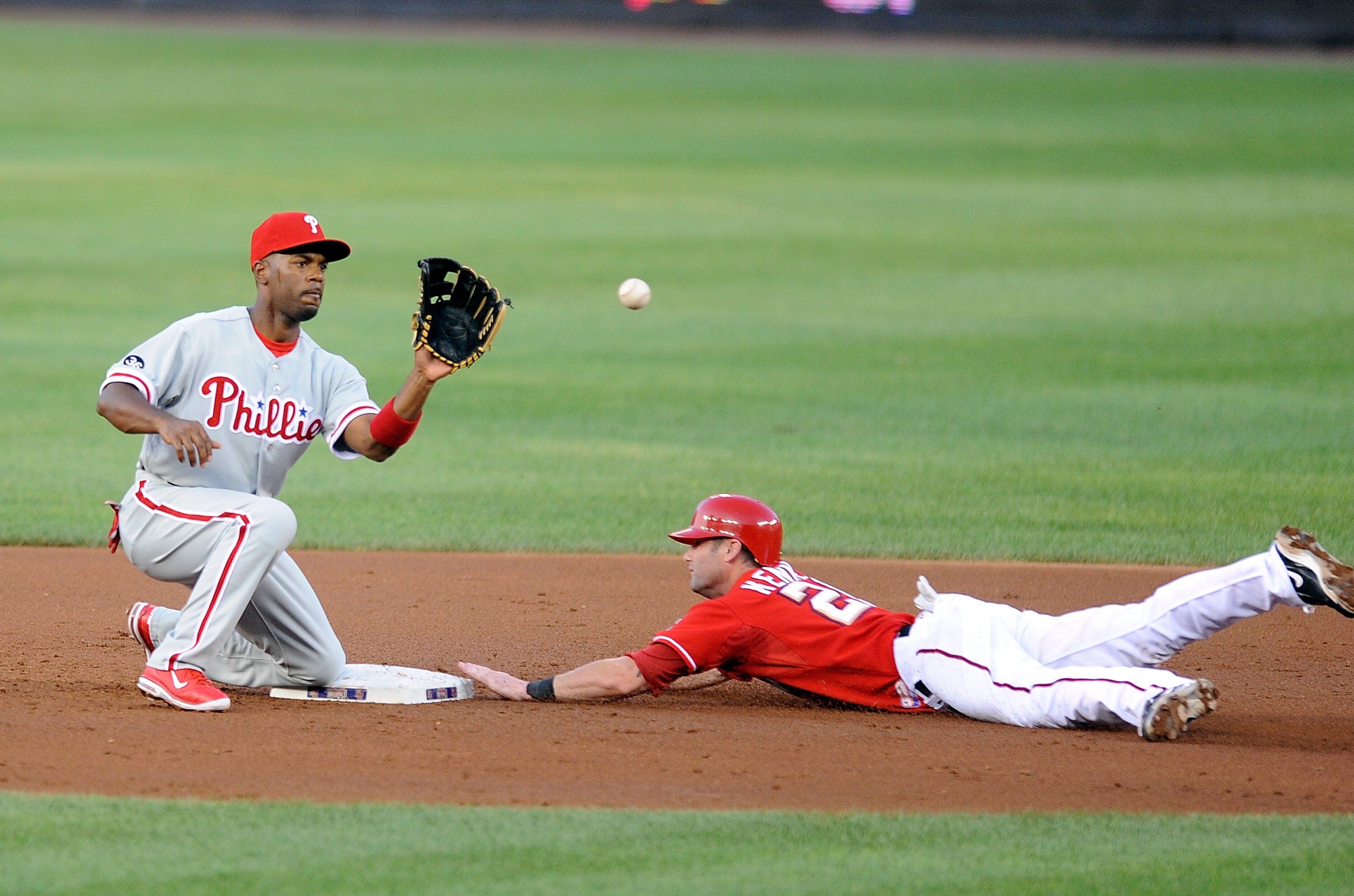 WASHINGTON - JULY 30:  Adam Kennedy #20 of the Washington Nationals steals second base ahead of the throw to Jimmy Rollins #11 of the Philadelphia Phillies at Nationals Park on July 30, 2010 in Washington, DC.  (Photo by Greg Fiume/Getty Images)