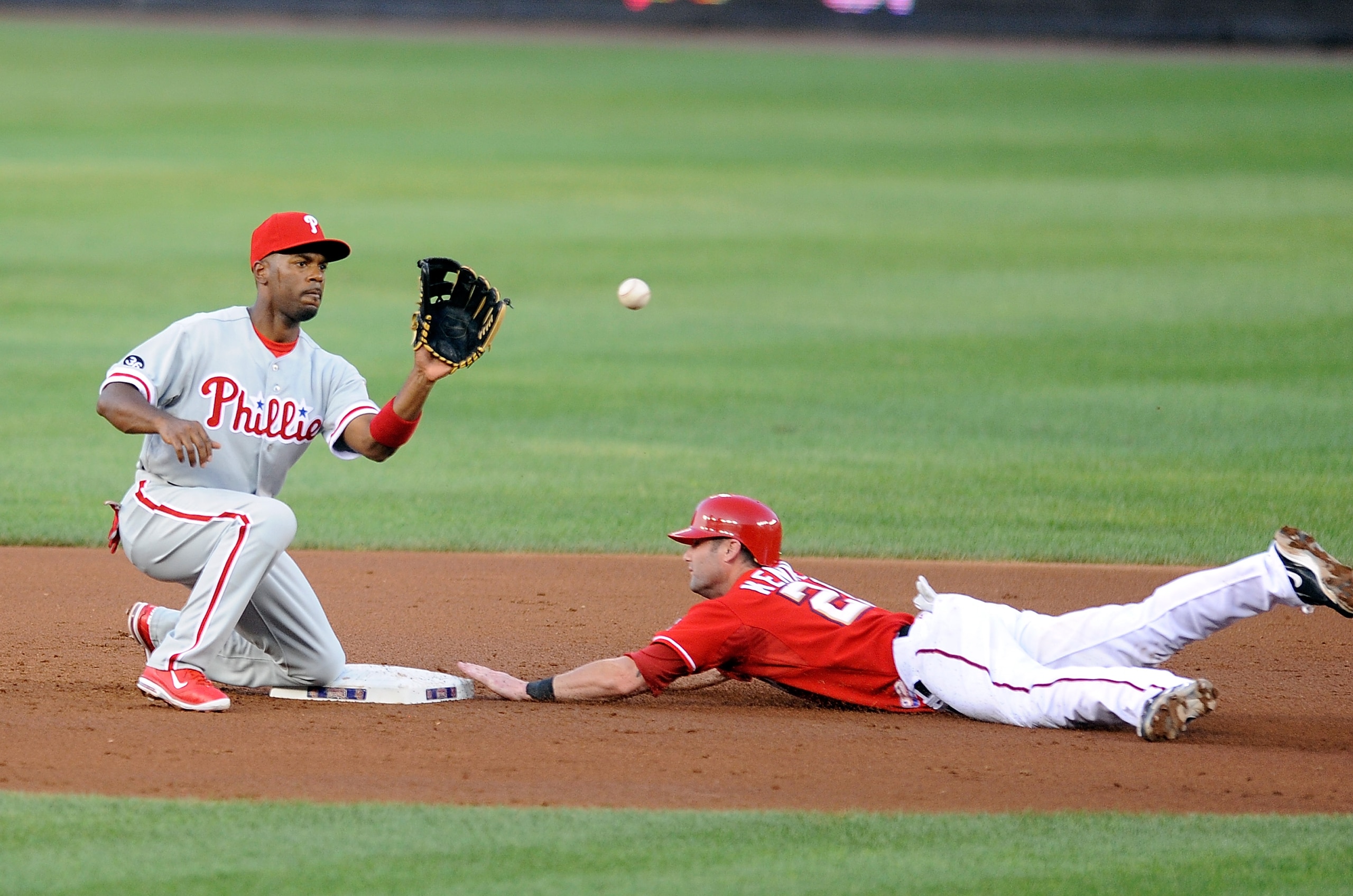 WASHINGTON - JULY 30:  Adam Kennedy #20 of the Washington Nationals steals second base ahead of the throw to Jimmy Rollins #11 of the Philadelphia Phillies at Nationals Park on July 30, 2010 in Washington, DC.  (Photo by Greg Fiume/Getty Images)