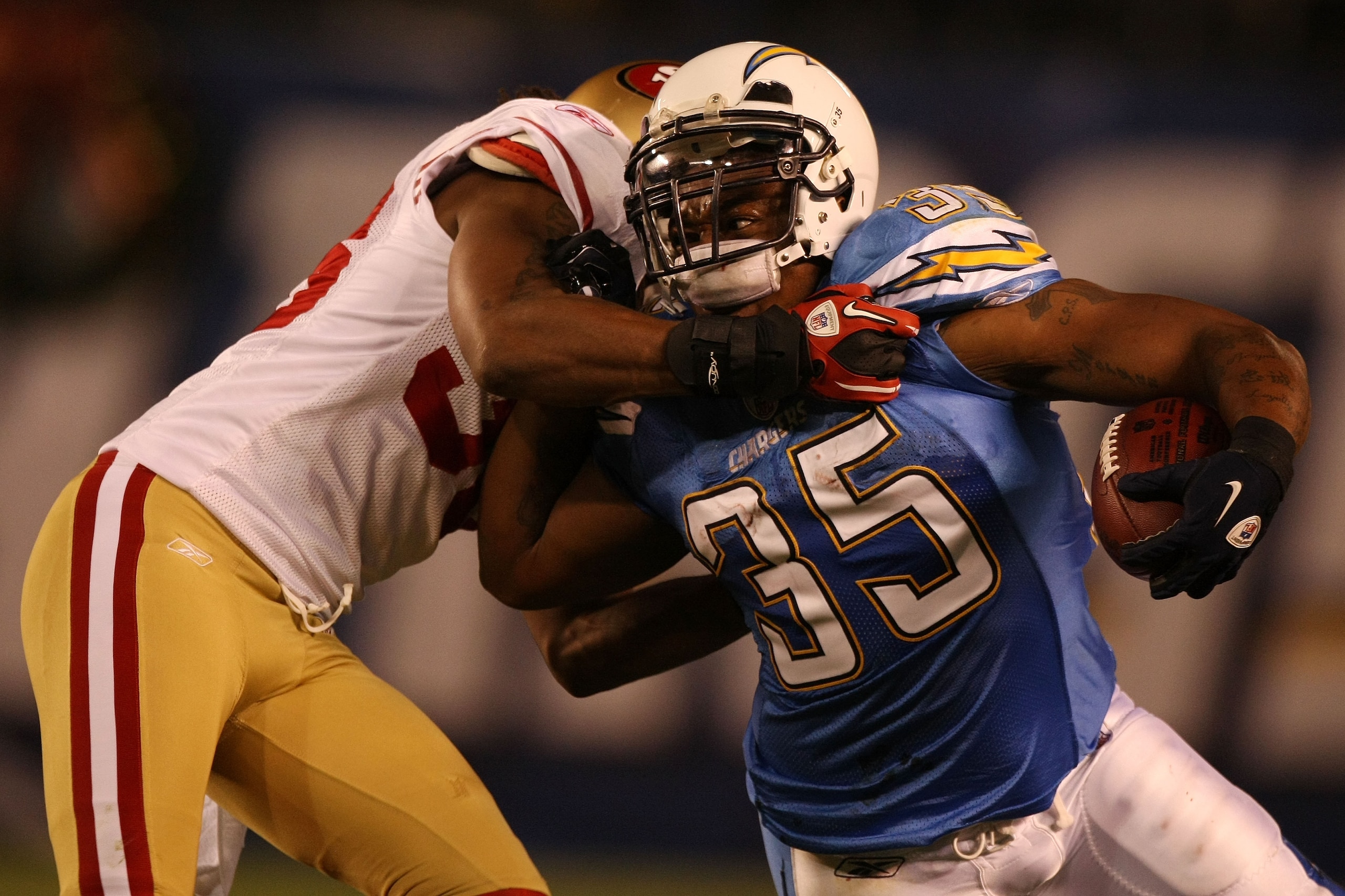 SAN DIEGO, CA - DECEMBER 16:  Running back Mike Tolbert #35 of the San Diego Chargers rushes with the ball as cornerback Shawntae Spencer #36 of the San Francisco 49ers trys to tackle him at Qualcomm Stadium on December 16, 2010 in San Diego, California.