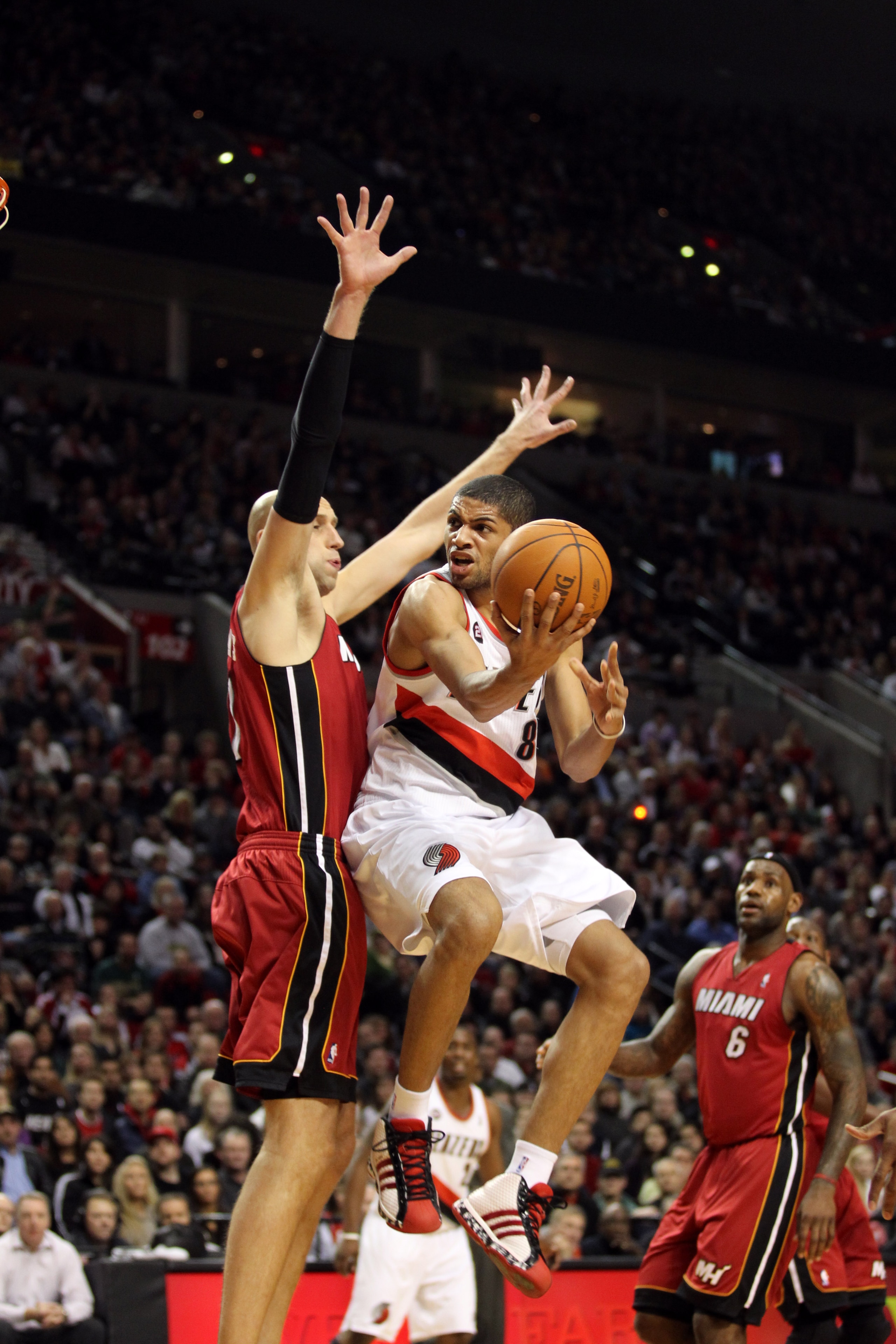 PORTLAND, OR - JANUARY 09: Nicolas Batum #88 of the Portland Trail Blazers goes to the basket against Zydrunas Ilgauskas #11 of the Miami Heat during a game on January 9, 2011 at the Rose Garden Arena in Portland, Oregon. NOTE TO USER: User expressly ackn