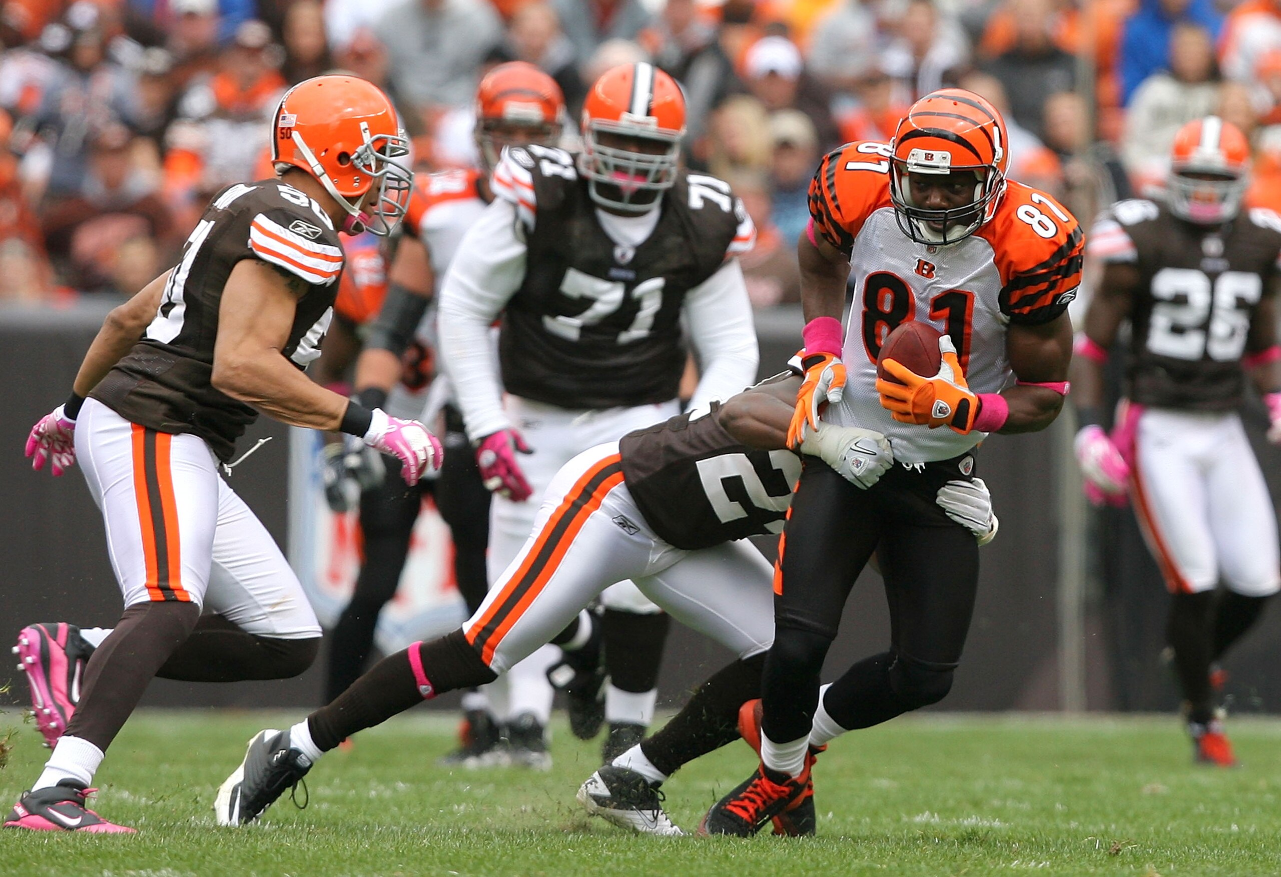 CLEVELAND - OCTOBER 03:  Wide receiver Terrell Owens #81 of the Cincinnati Bengals is hit by defenders Sheldon Brown #24 and Eric Barton #50 (L) of the Cleveland Browns at Cleveland Browns Stadium on October 3, 2010 in Cleveland, Ohio.  (Photo by Matt Sul
