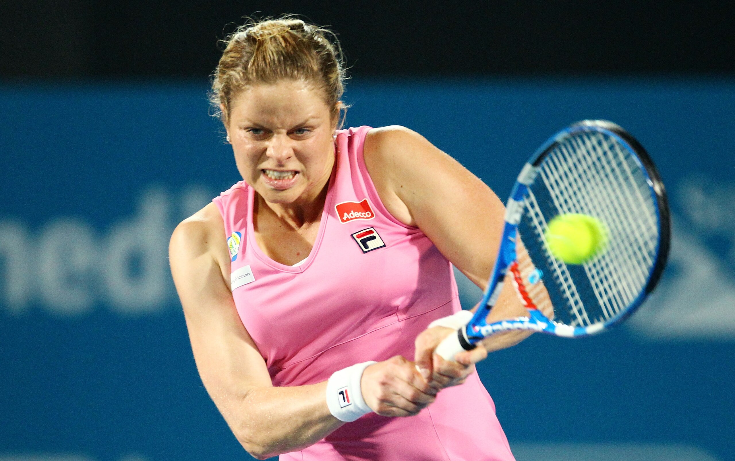 SYDNEY, AUSTRALIA - JANUARY 14:  Kim Clijsters of Belgium plays a backhand in the womens final against Na Li of China during day six of the 2011 Medibank International at Sydney Olympic Park Tennis Centre on January 14, 2011 in Sydney, Australia.  (Photo 